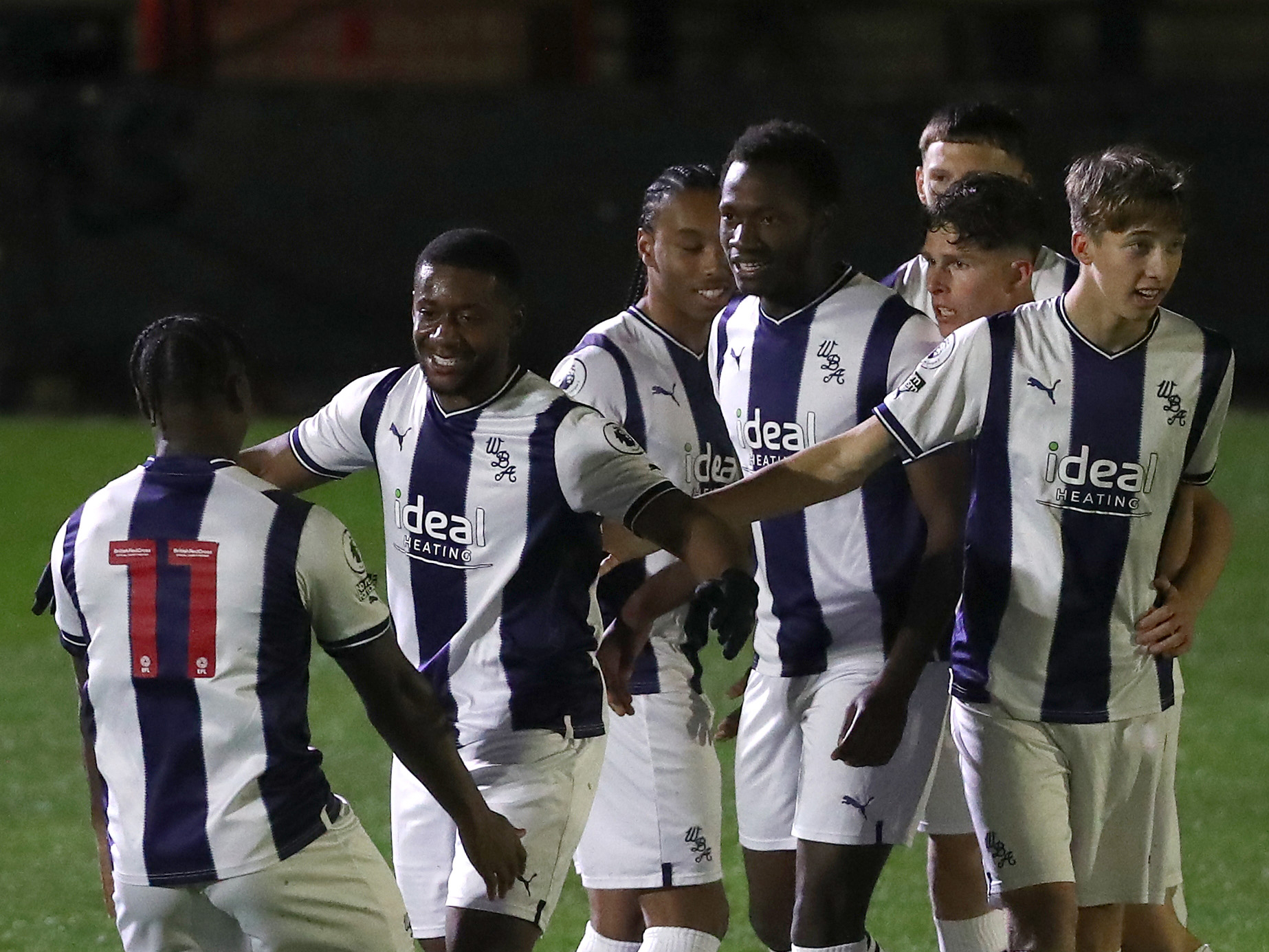 Albion PL2 players celebrate after their first goal against Stoke