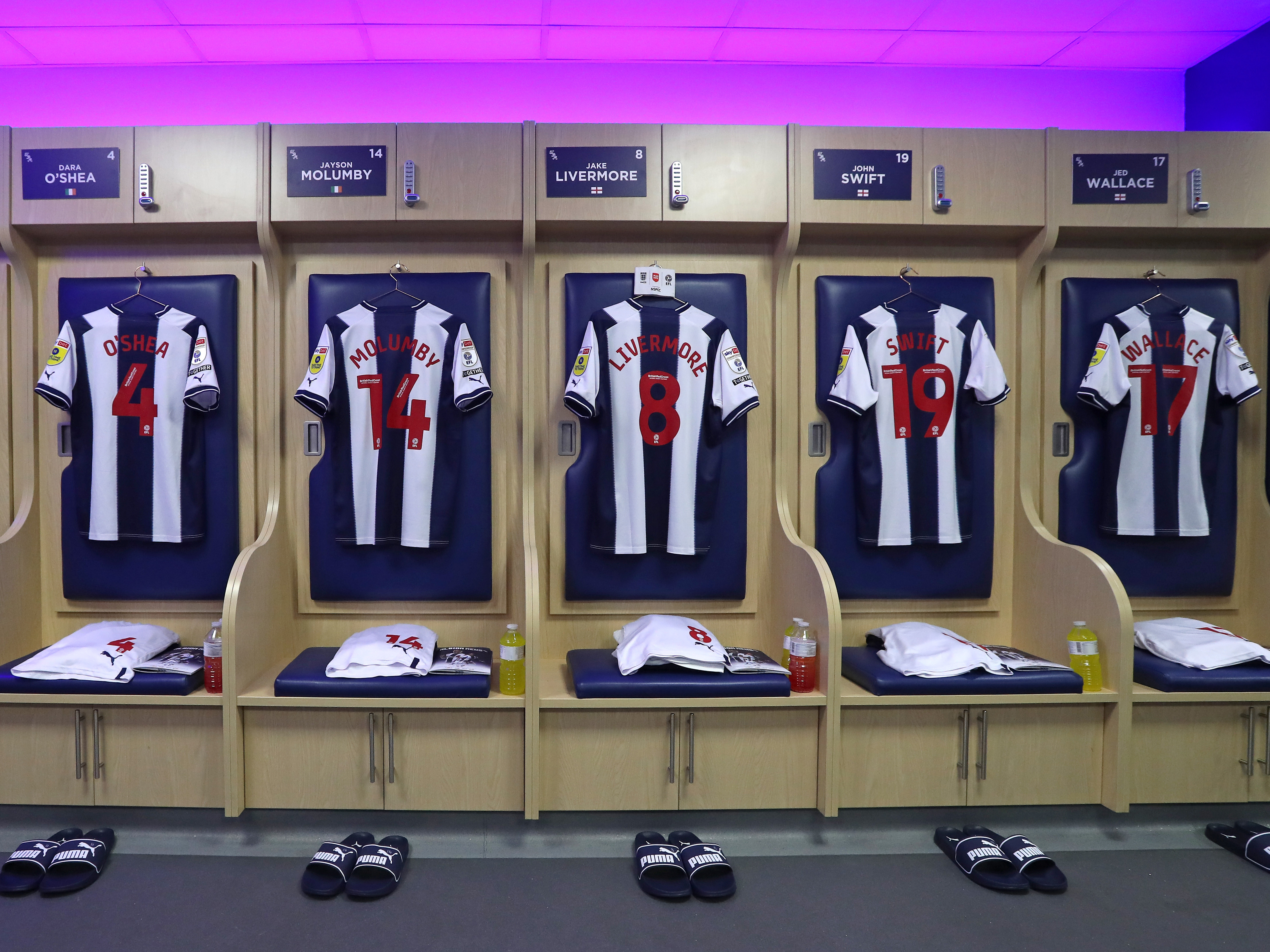 Albion shirts hang up in the dressing room at The Hawthorns