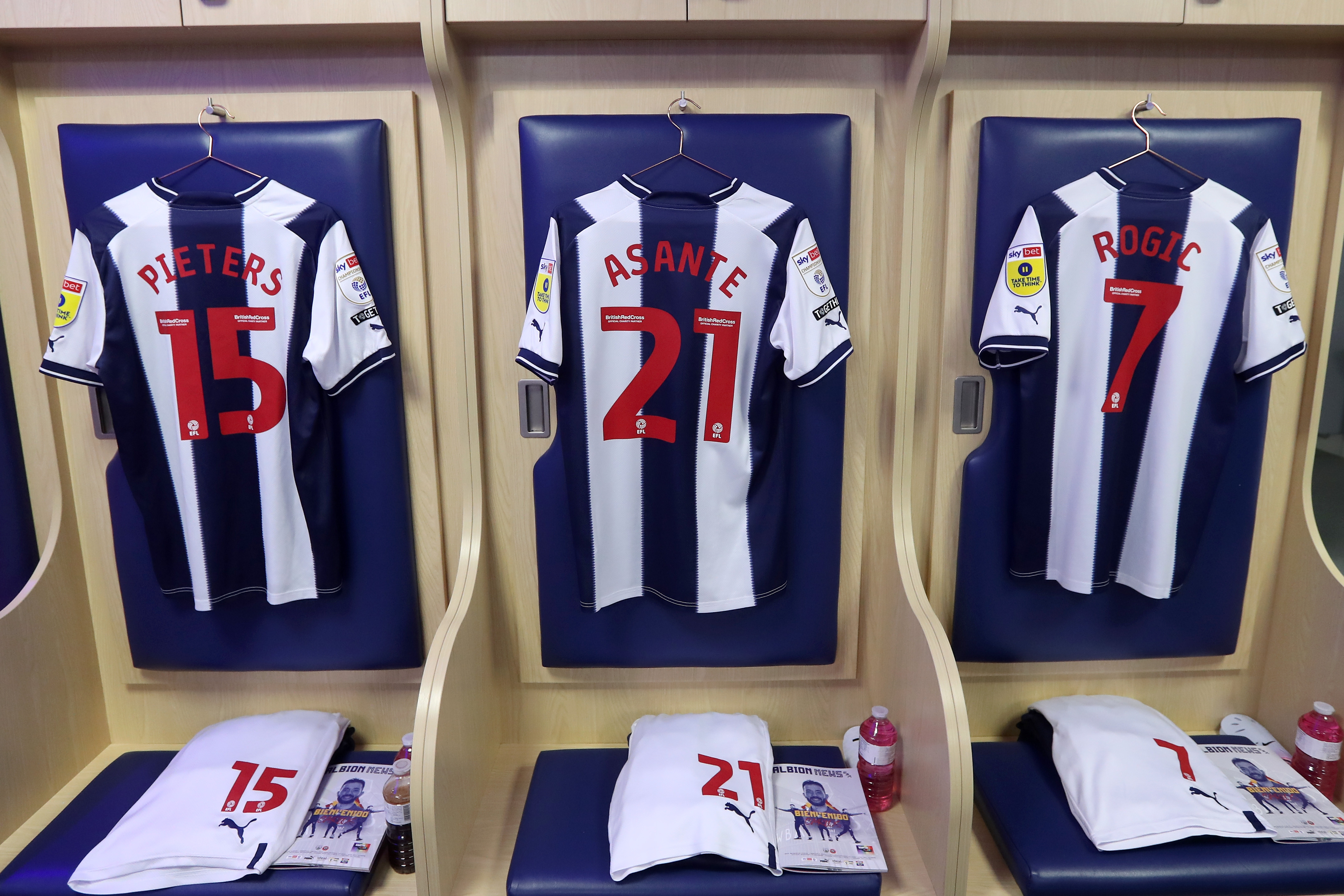 Albion home shirts hanging in the dressing room.