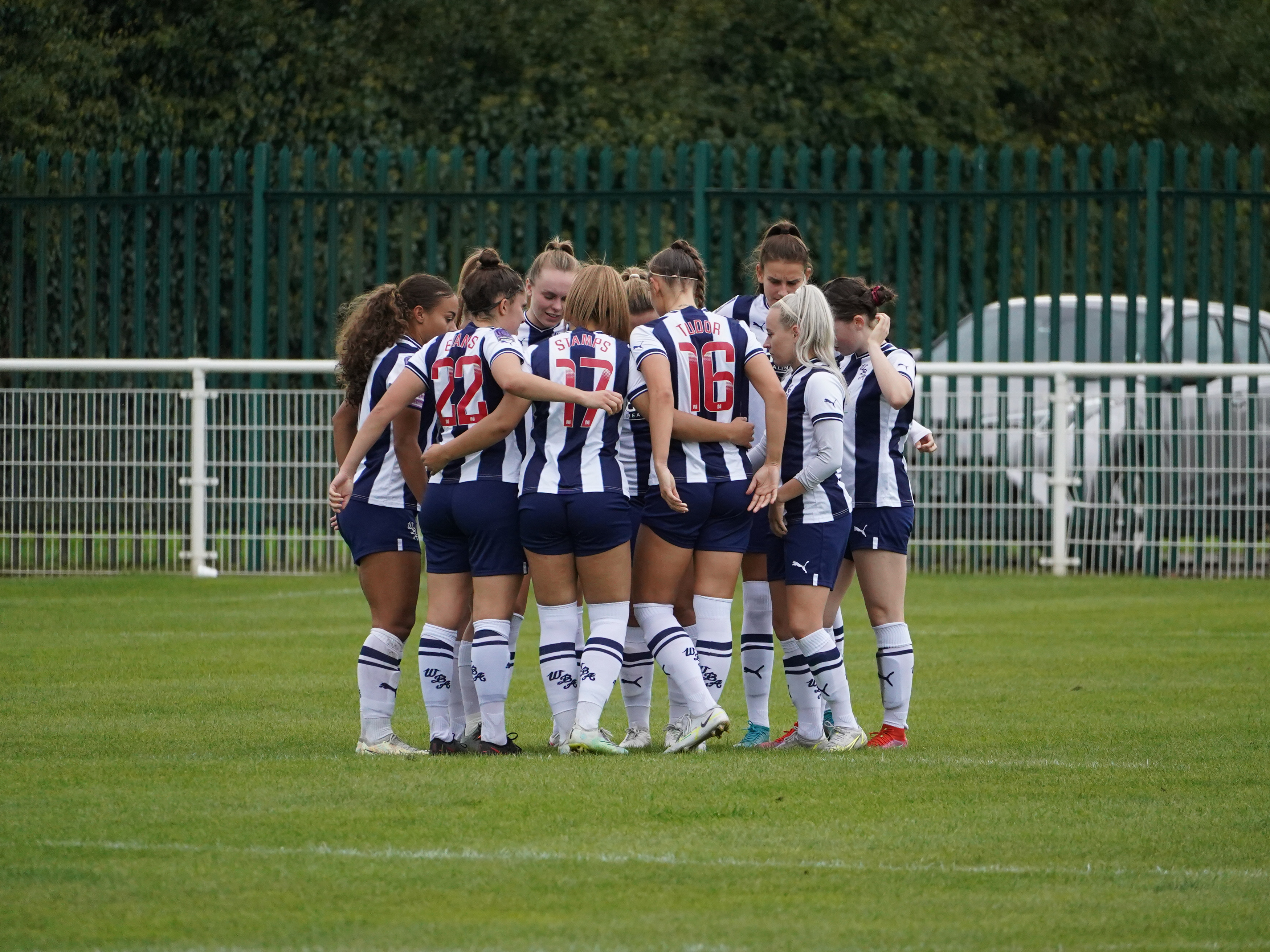 An image of the Albion Women team in a huddle before a match