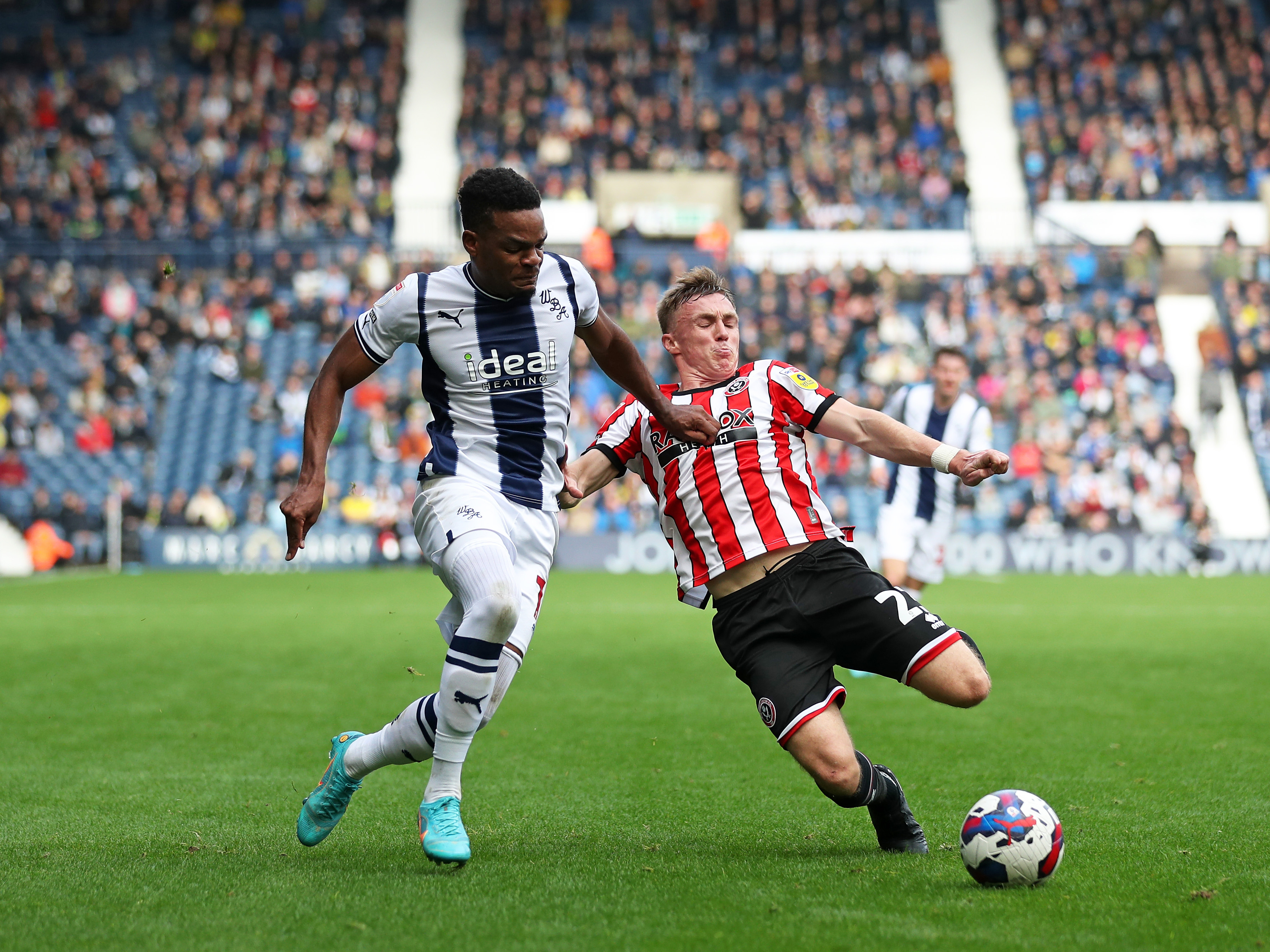 An image of Grady Diangana dribbling against a Sheffield United defender