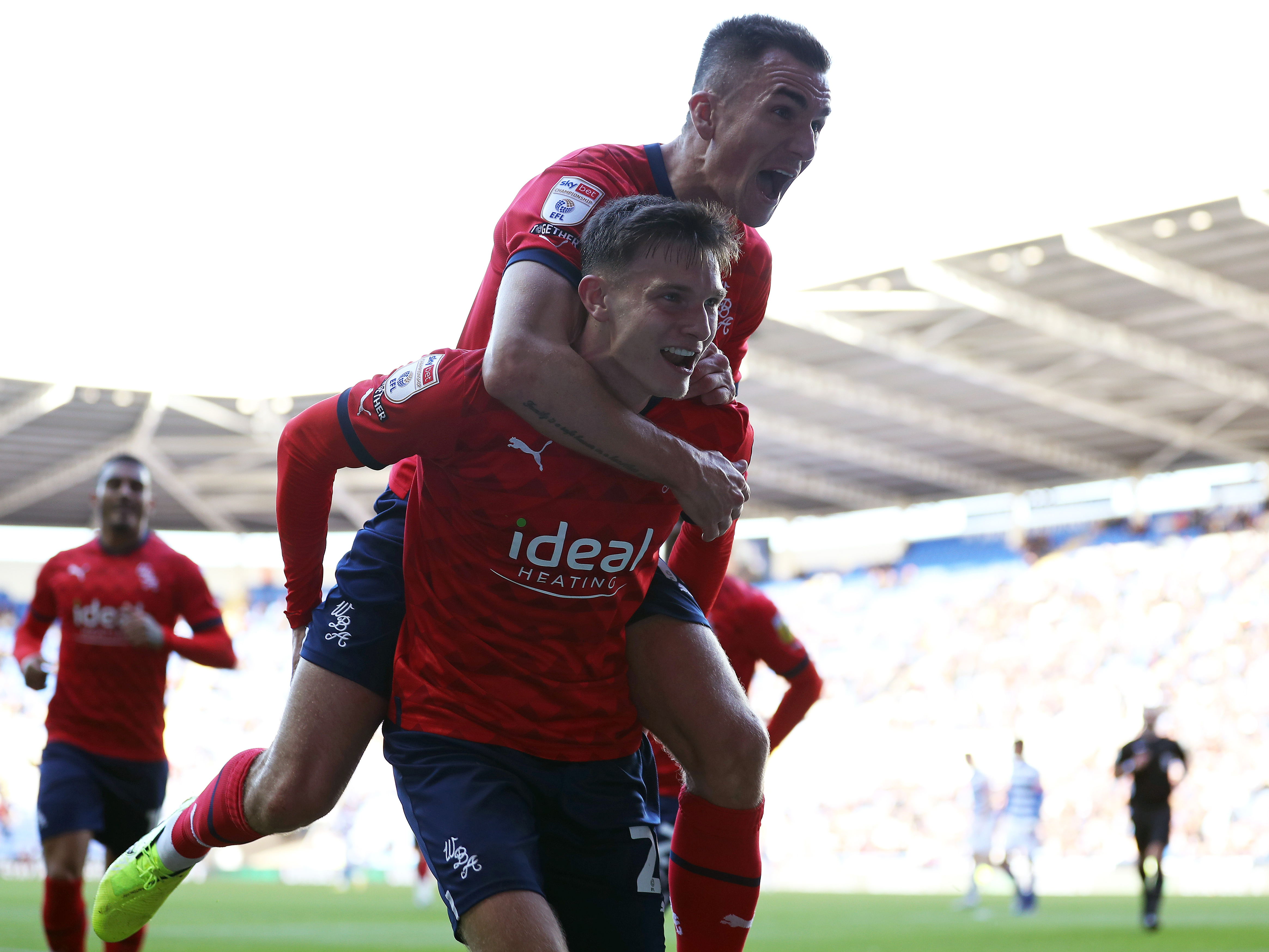 An image of Taylor Gardner-Hickman celebrating with Jed Wallace and the Albion fans after his goal at Reading