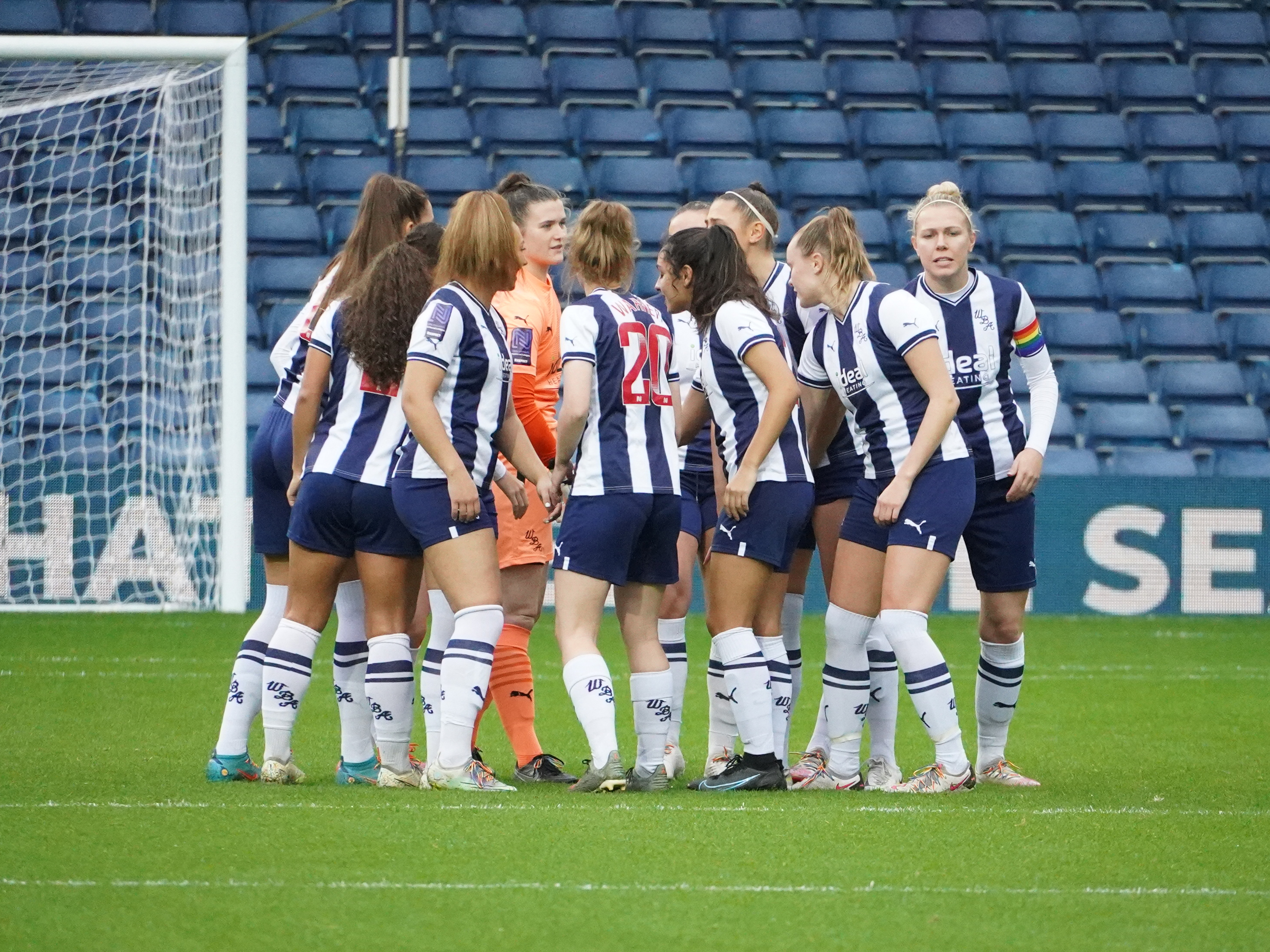 An image of the Albion Women's team in a huddle
