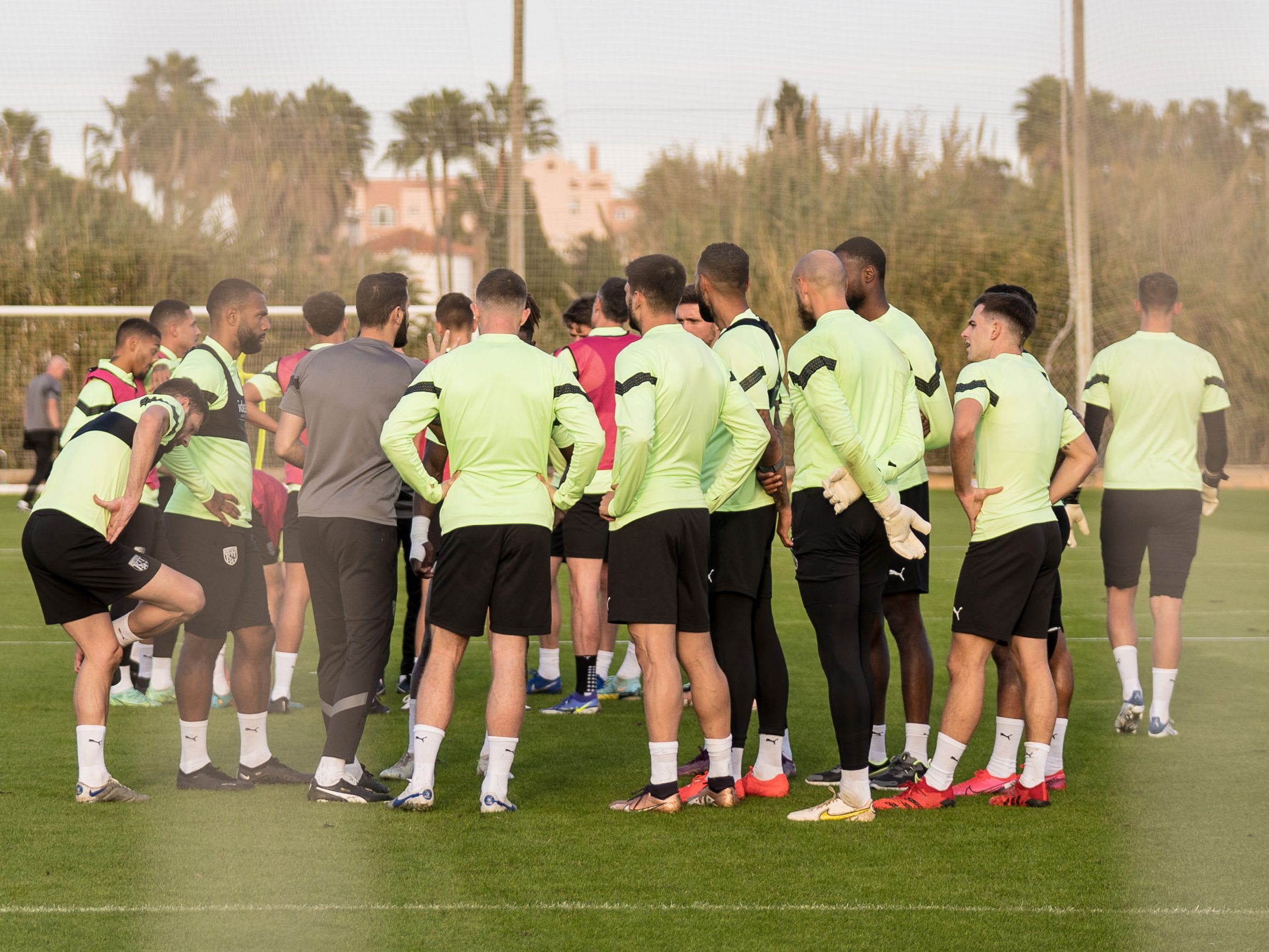 Albion players huddle on the pitch in Spain