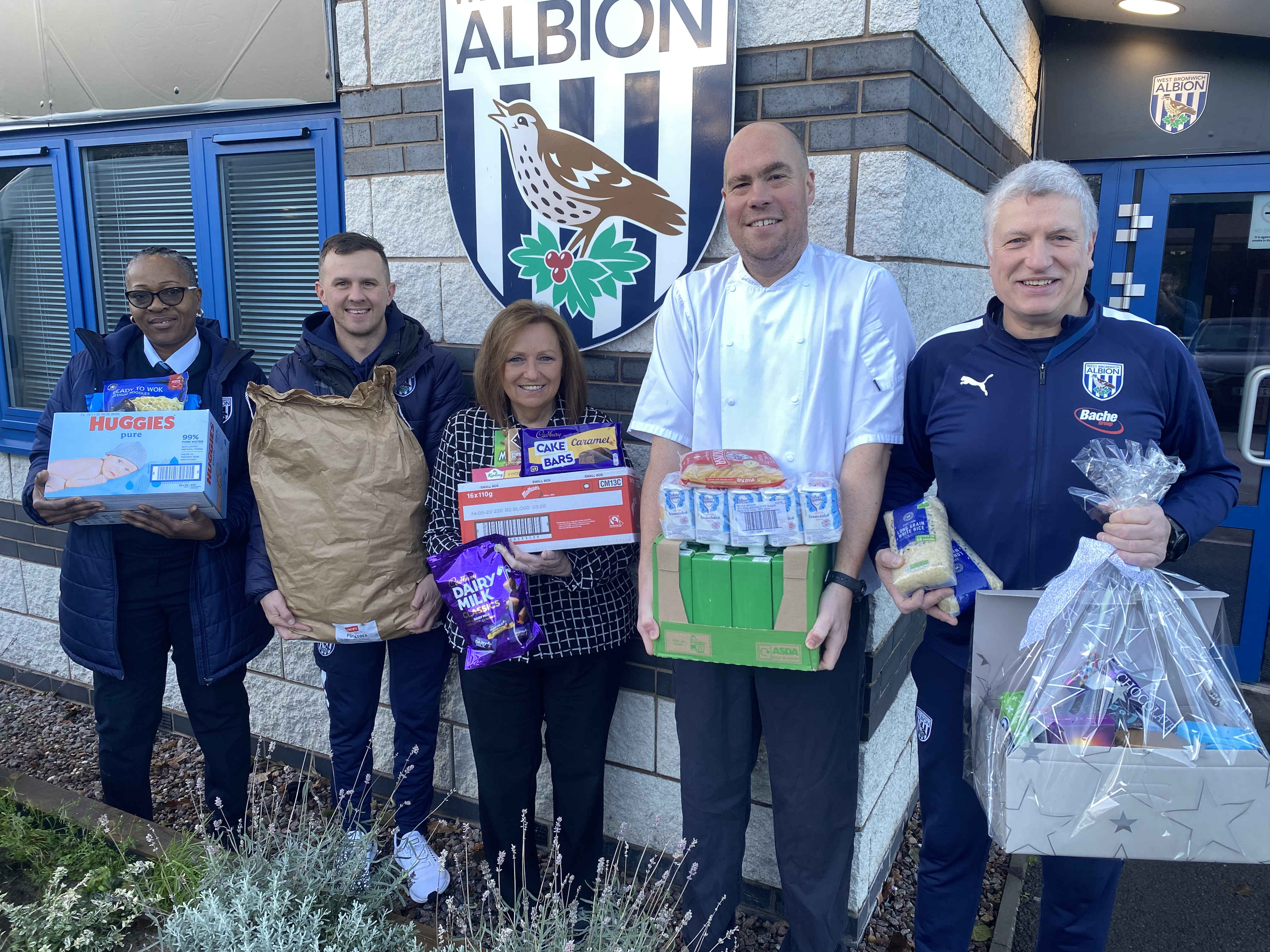 An image of Albion staff members with a foodbank donation