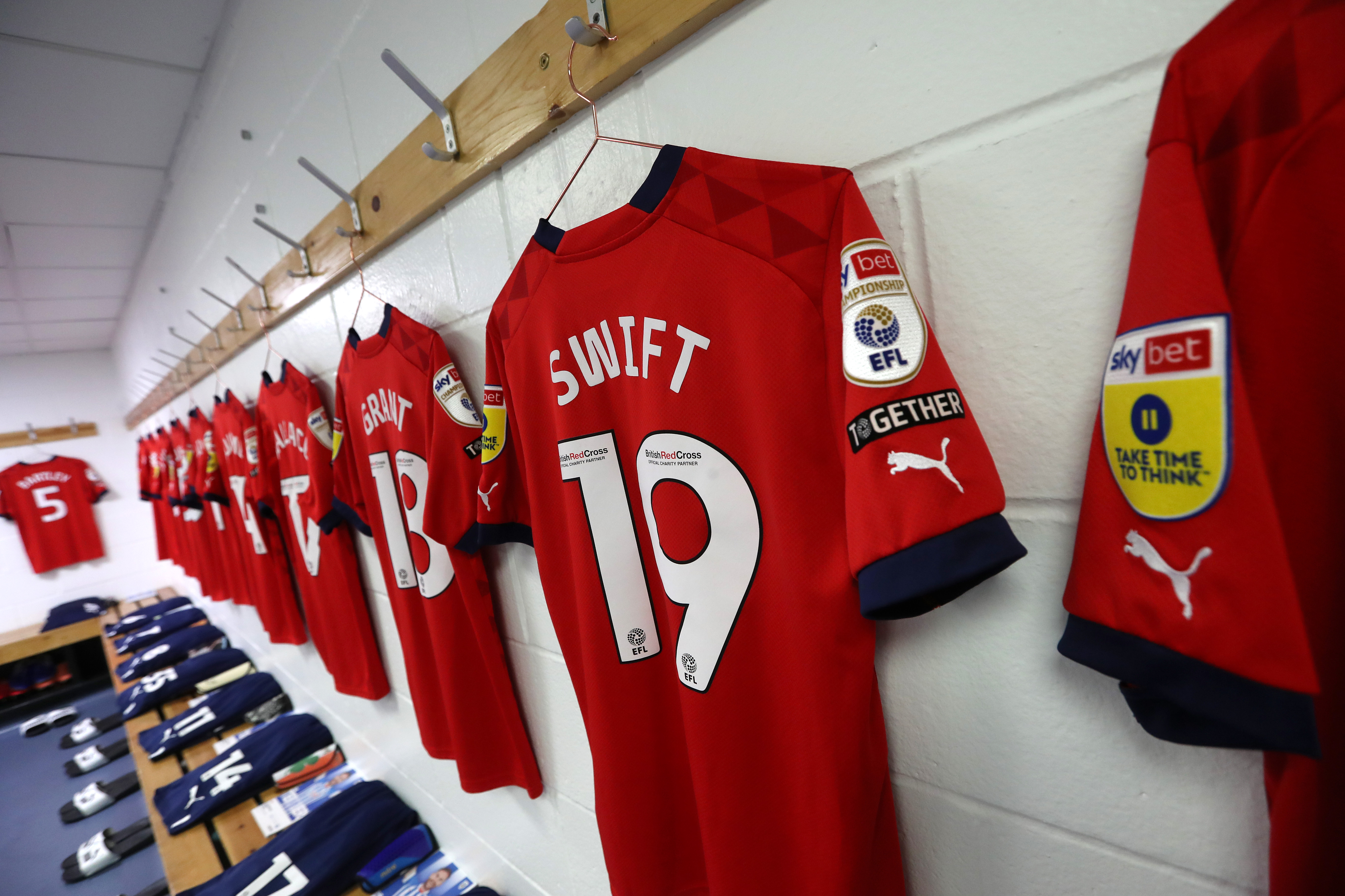 John Swift's red third shirt hanging up in the dressing room