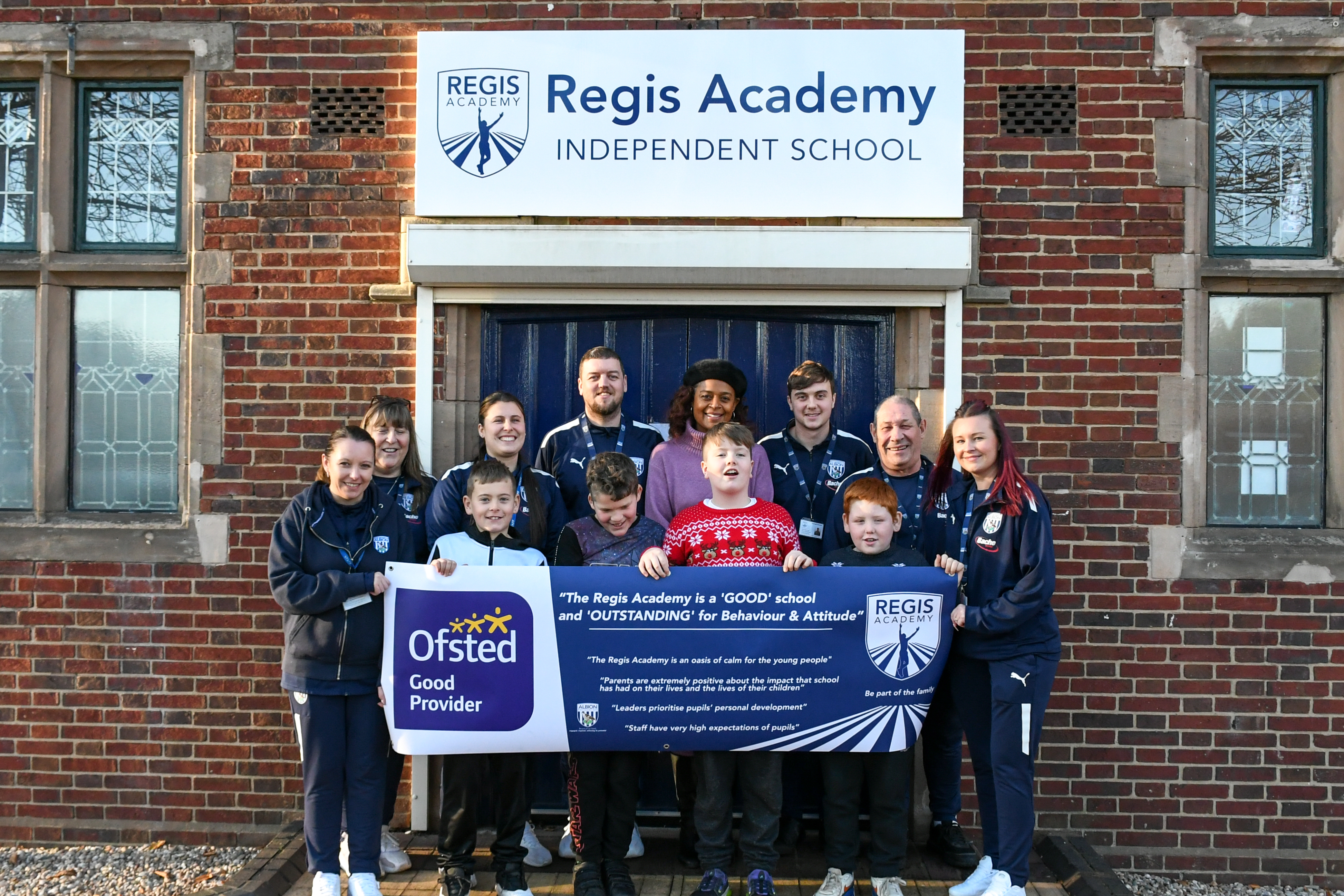 Julia Regis with staff and student outside The Regis Academy