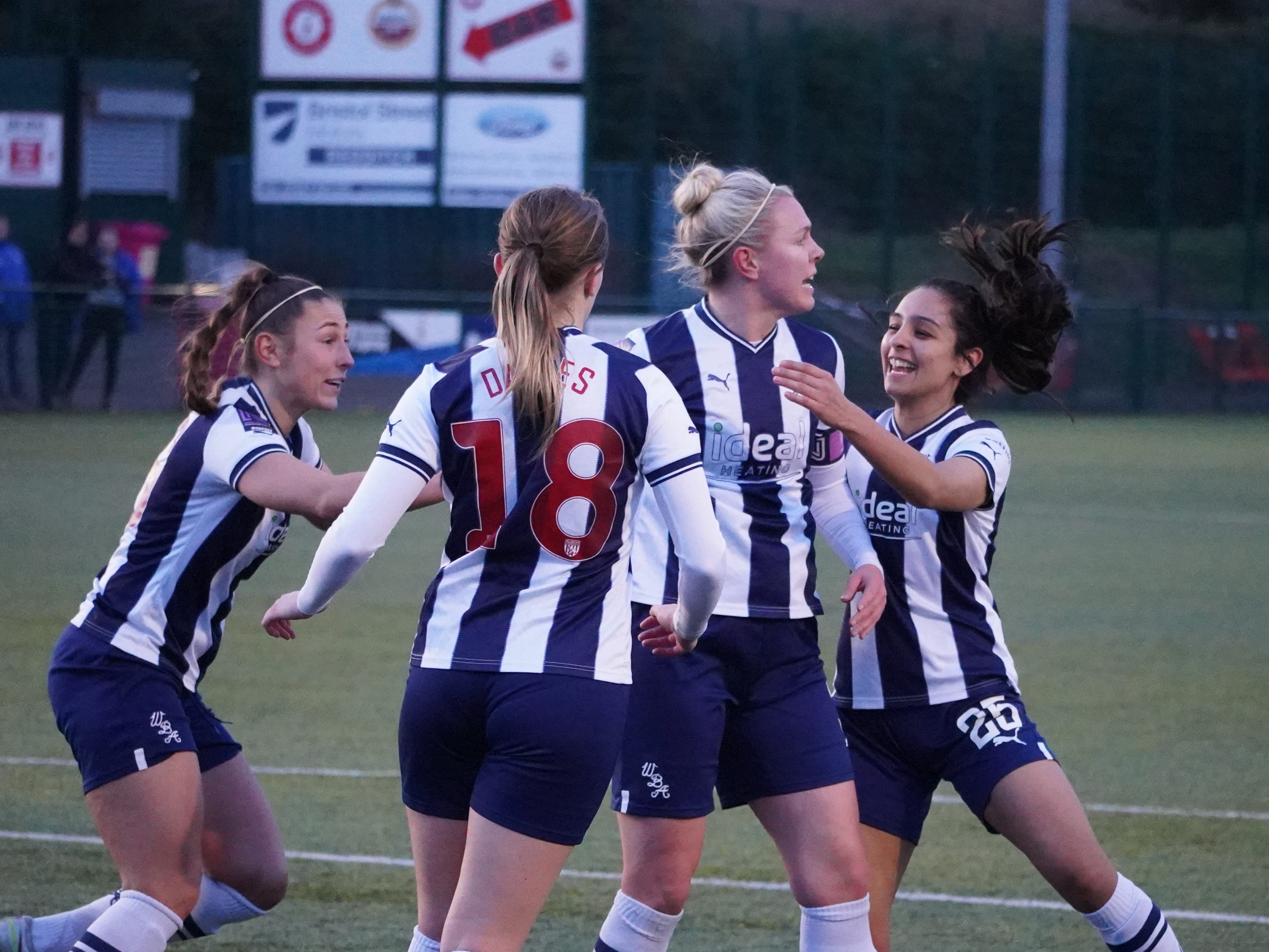 An image of the Albion Women team celebrating a goal against Leafield
