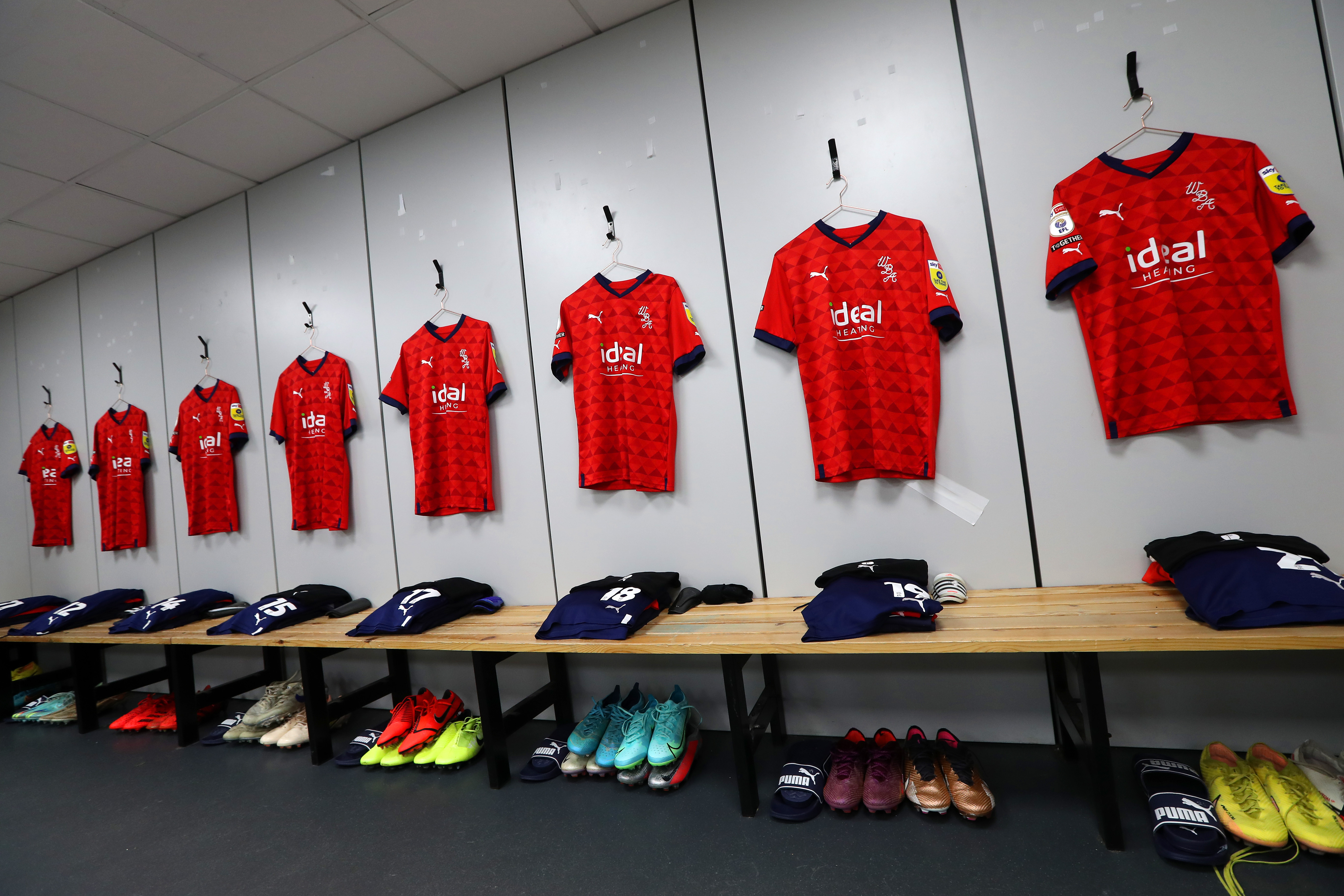 Albion's red shirts hanging up in the dressing room
