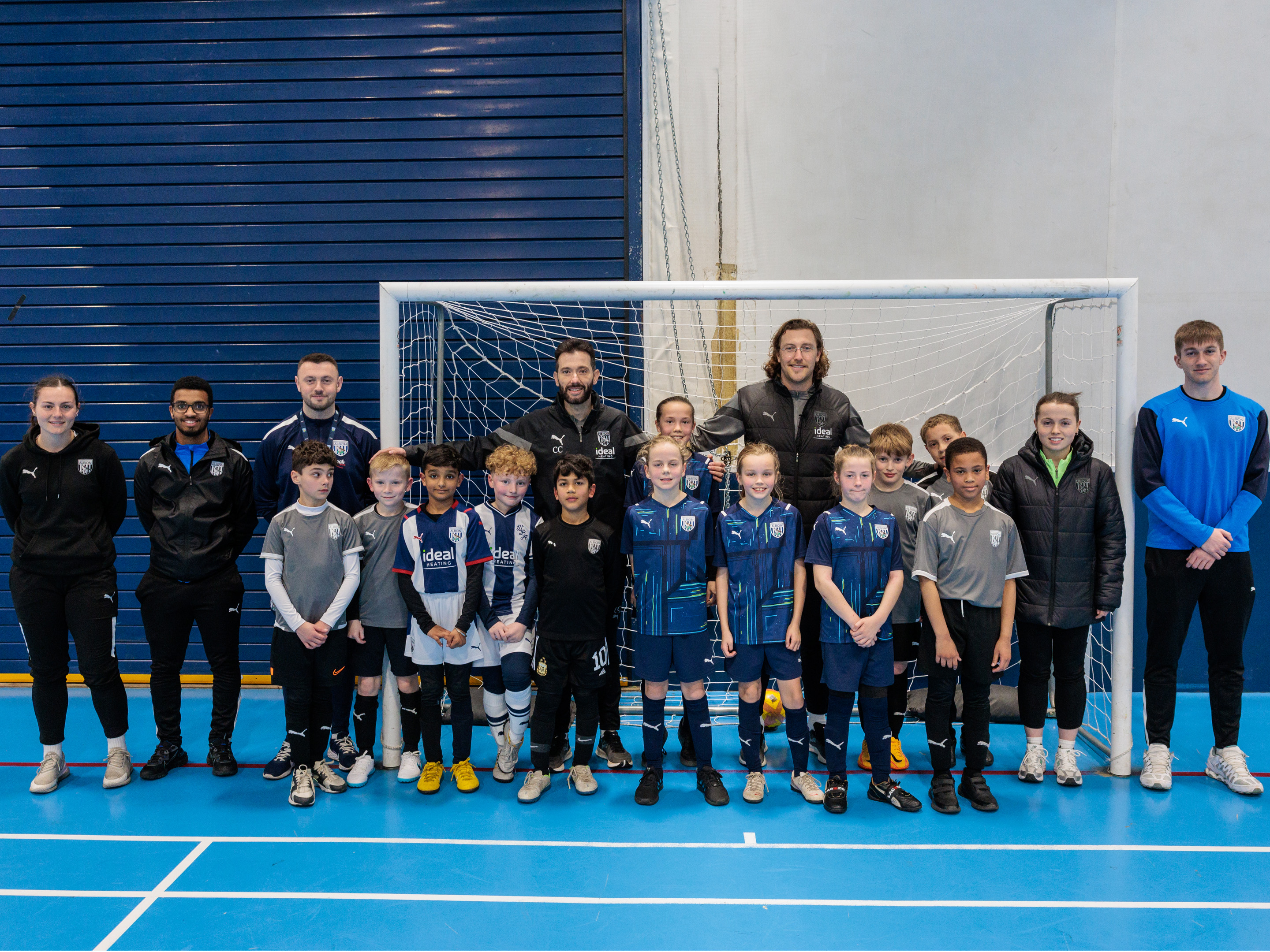 Carlos Corberán and first team coach Michael Hefele with participants from The Albion Foundation player pathway.
