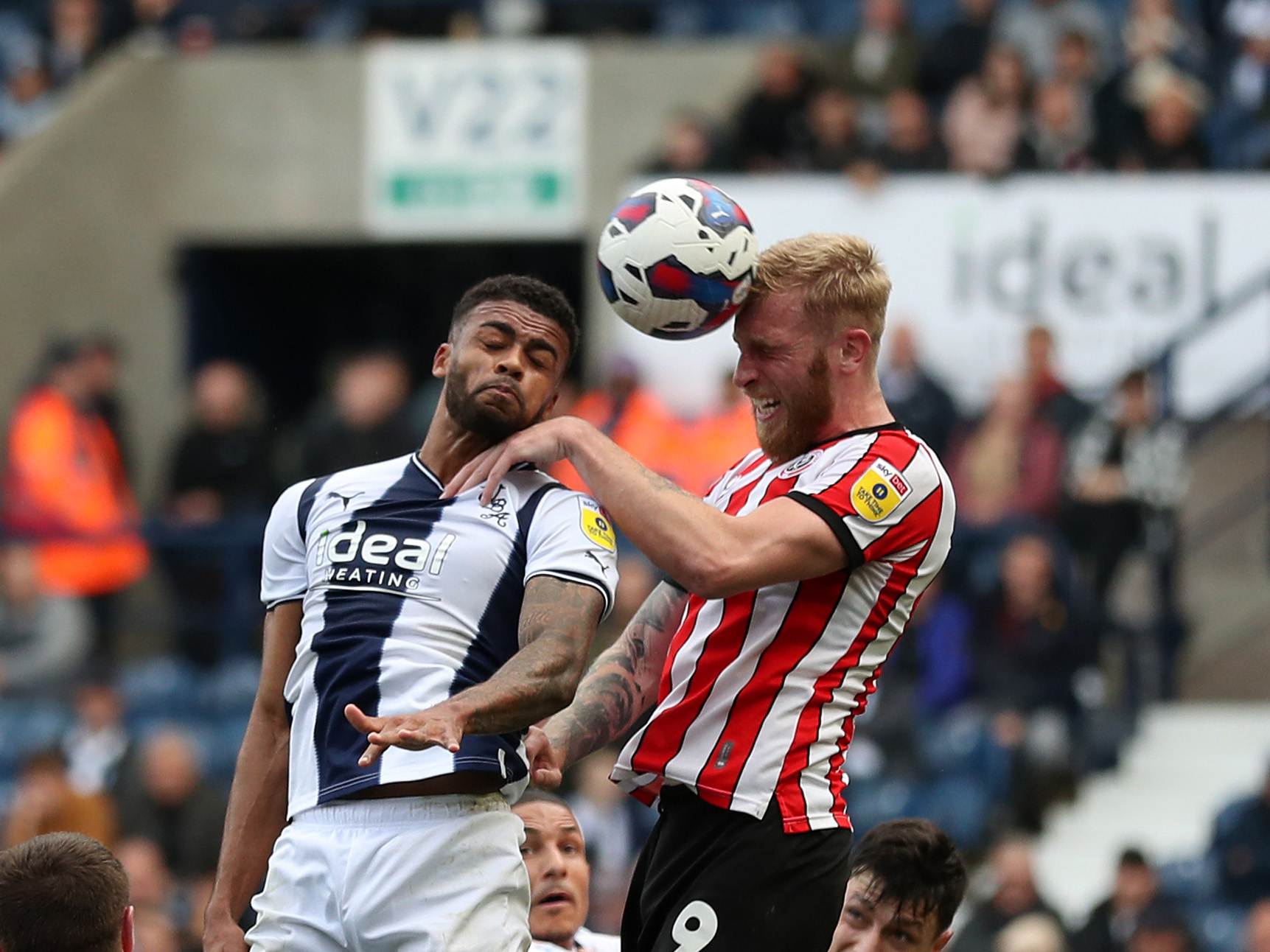 Darnell Furlong jumps for the ball with Sheffield United's Oli McBurnie