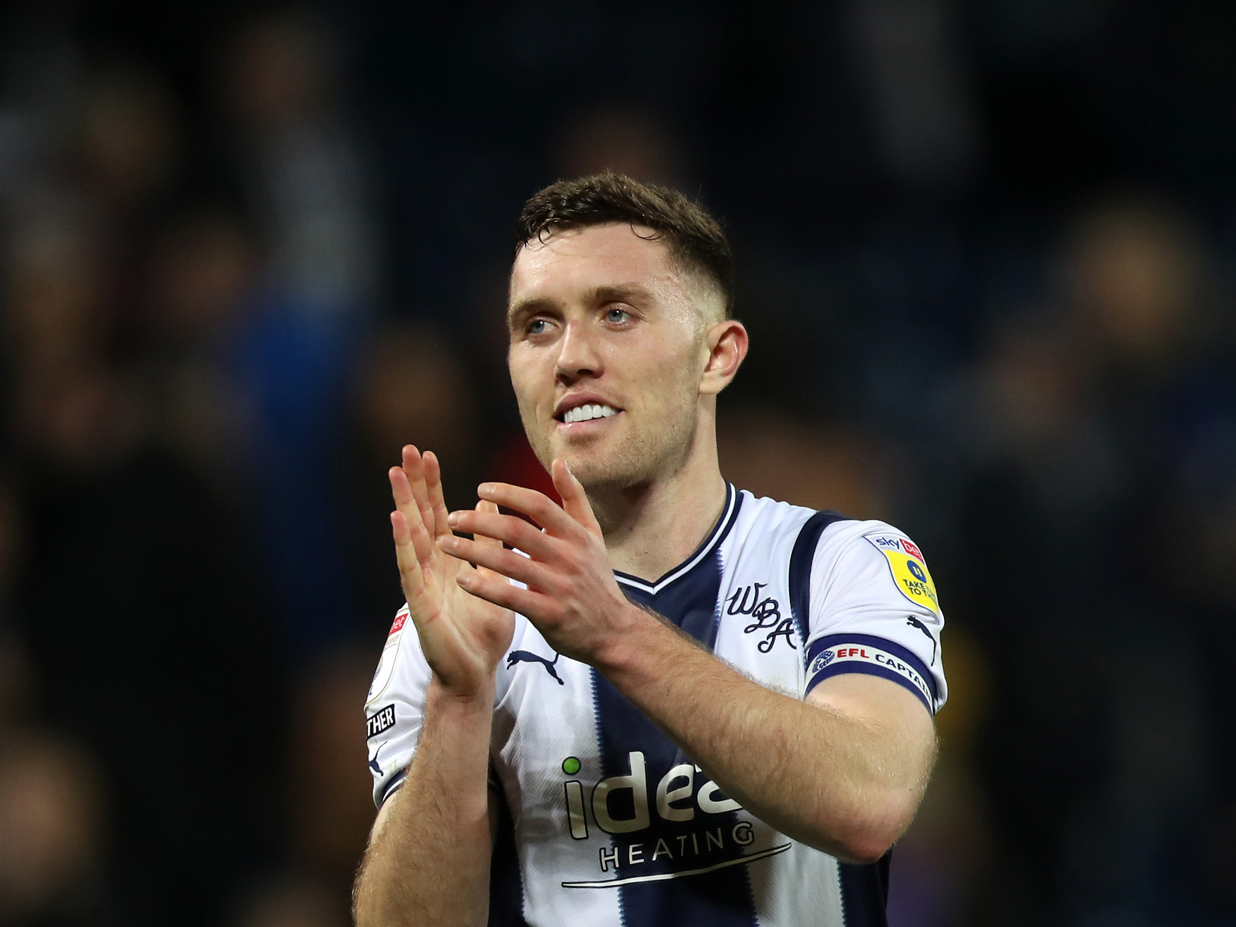 Dara O'Shea applauds the home fans at The Hawthorns