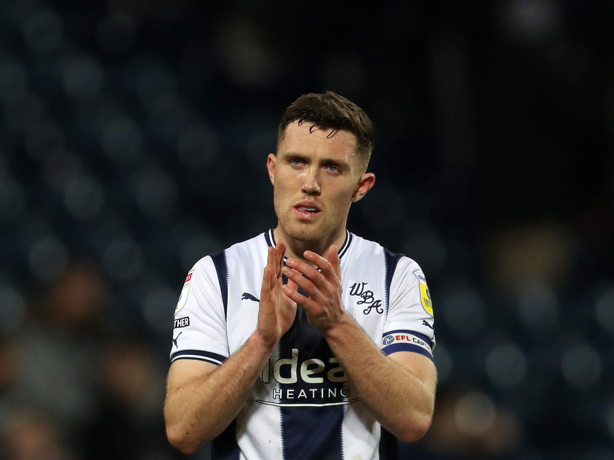 Dara O'Shea applauds the home fans at The Hawthorns