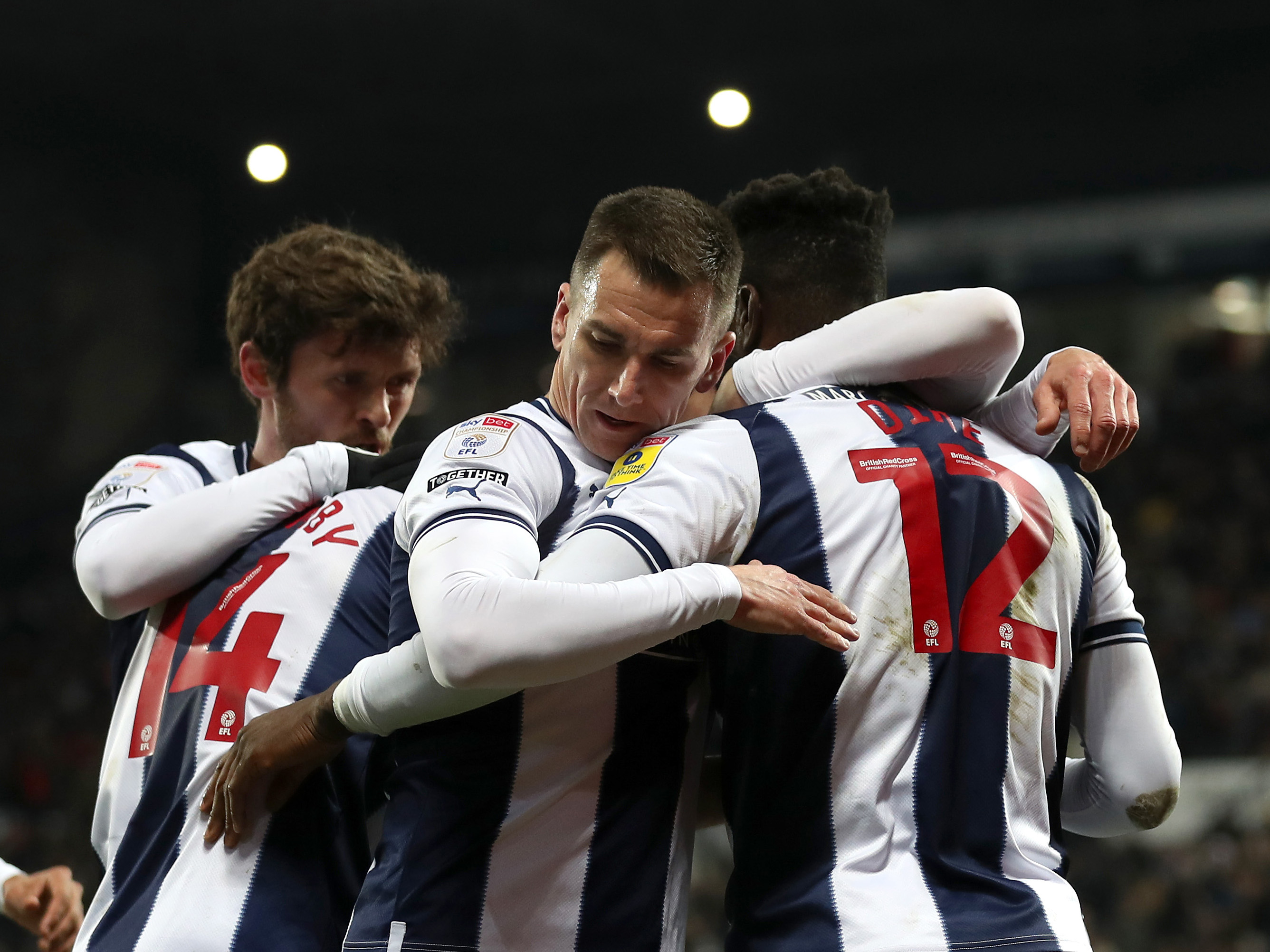 Albion players in a huddle after scoring a goal