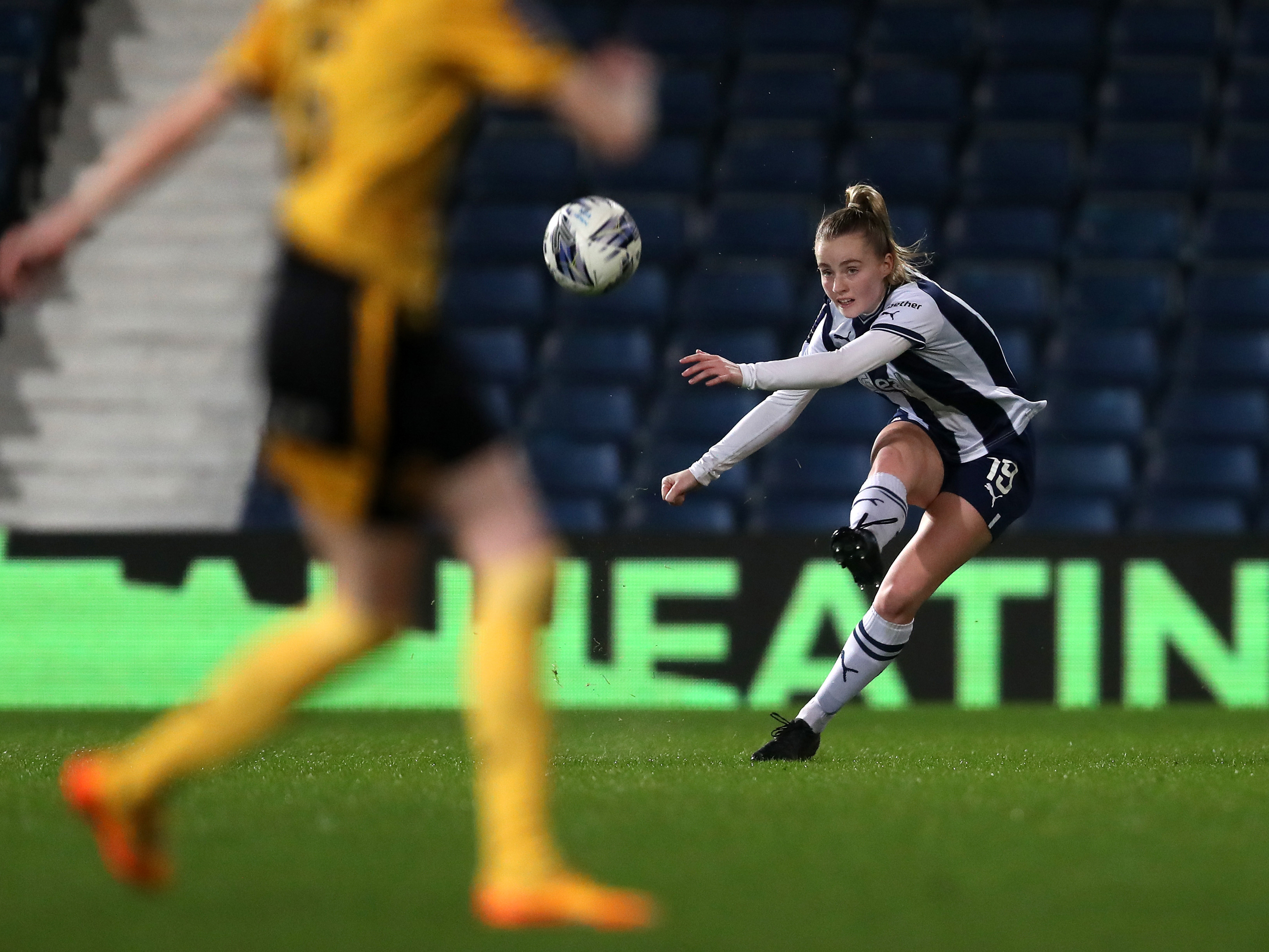 An image of Albion Women player Maria Timms passing the ball