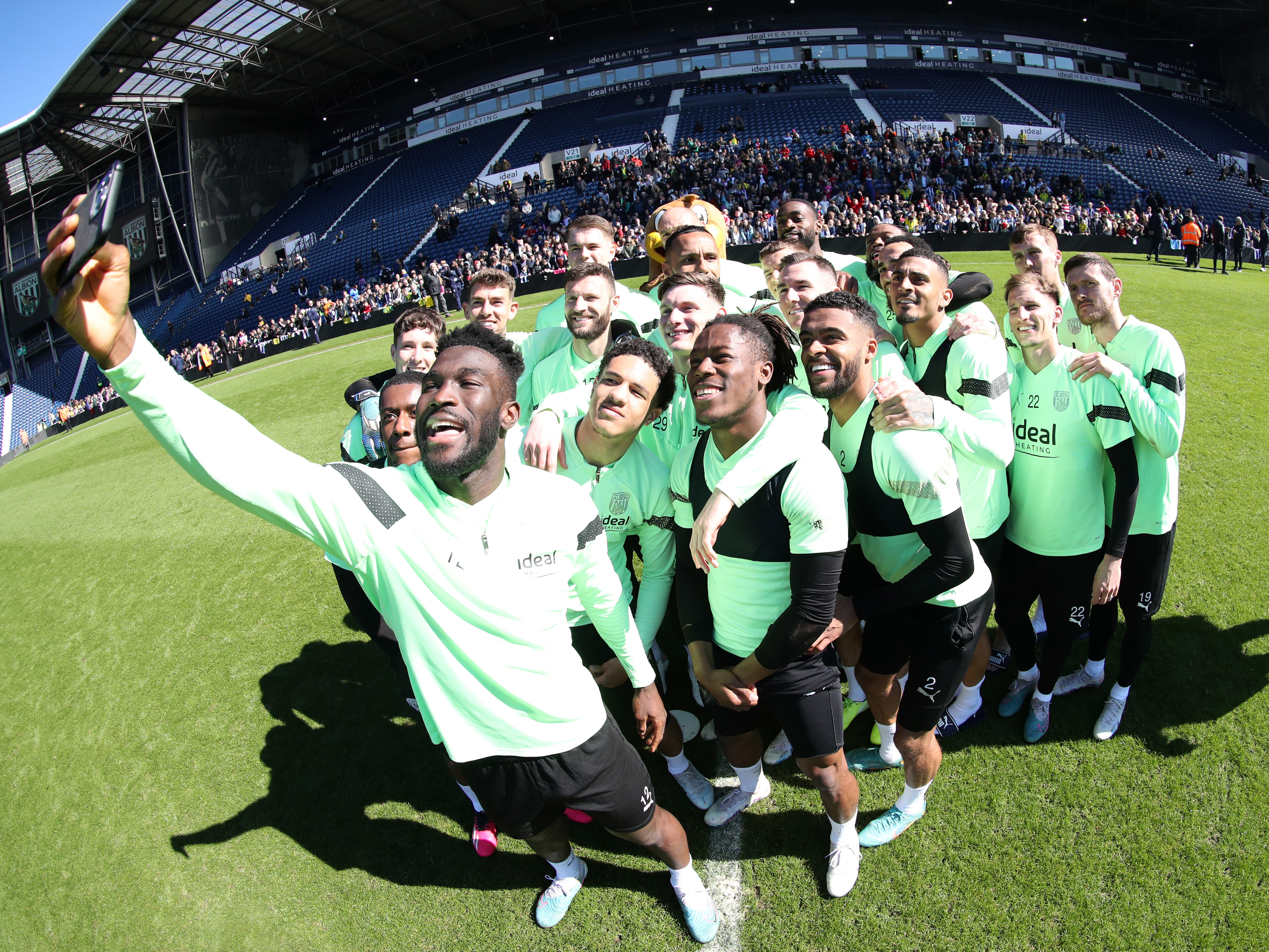 Albion players pose for a selfie at The Hawthorns in front of the East Stand