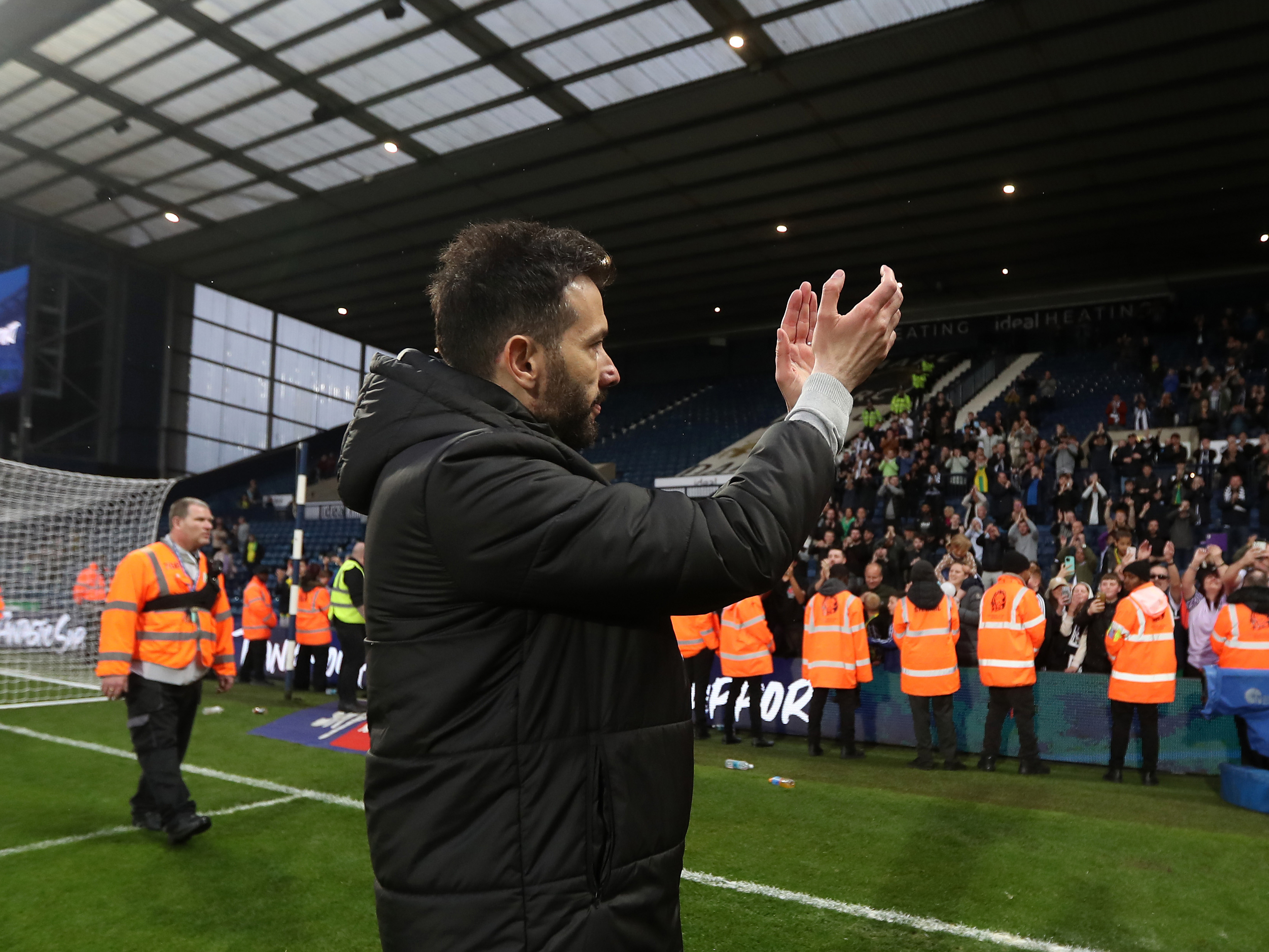 An image of Carlos Corberan applauding Albion supporters