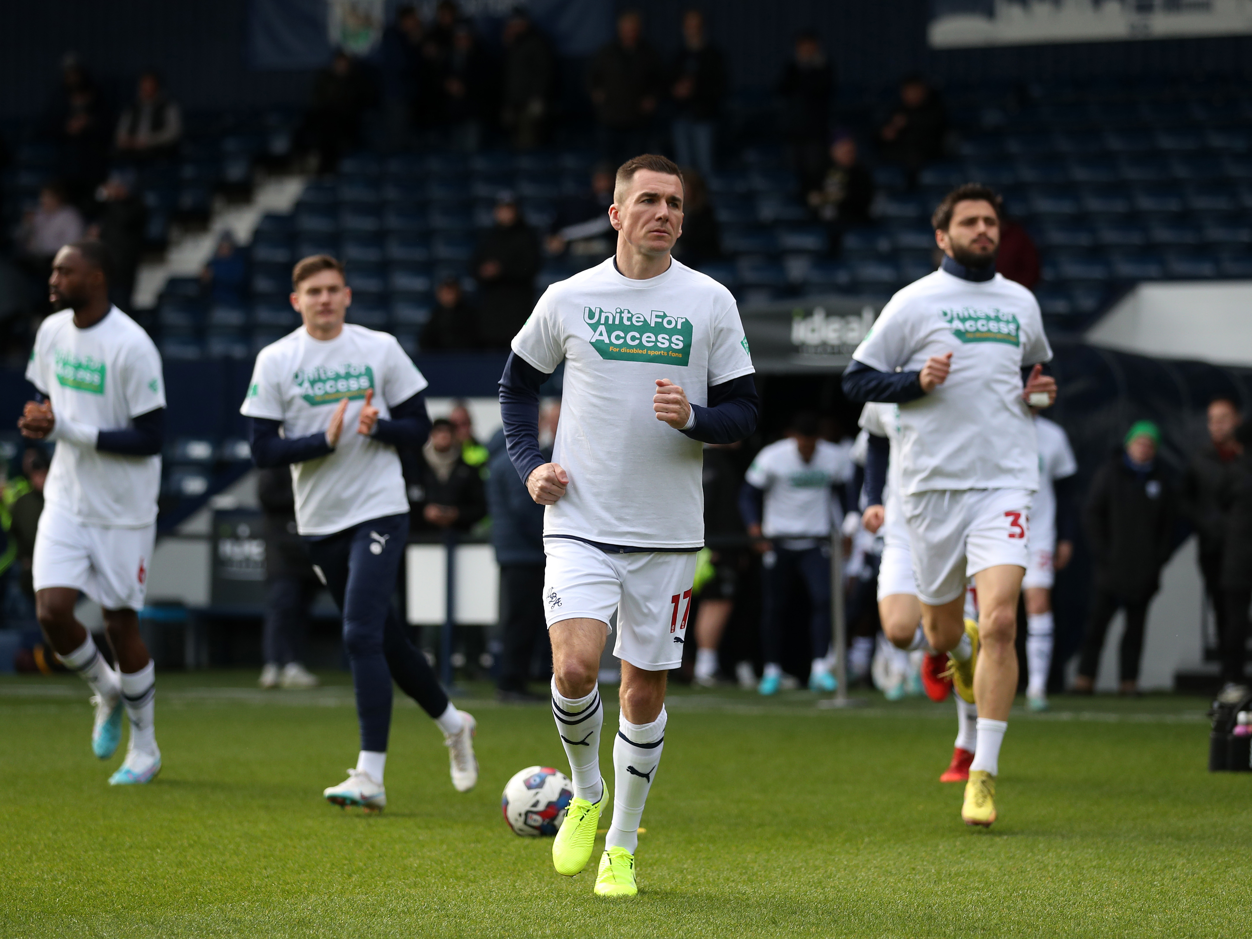 An image of Jed Wallace, and other Albion players, wearing Level Playing Field warm-up shirts