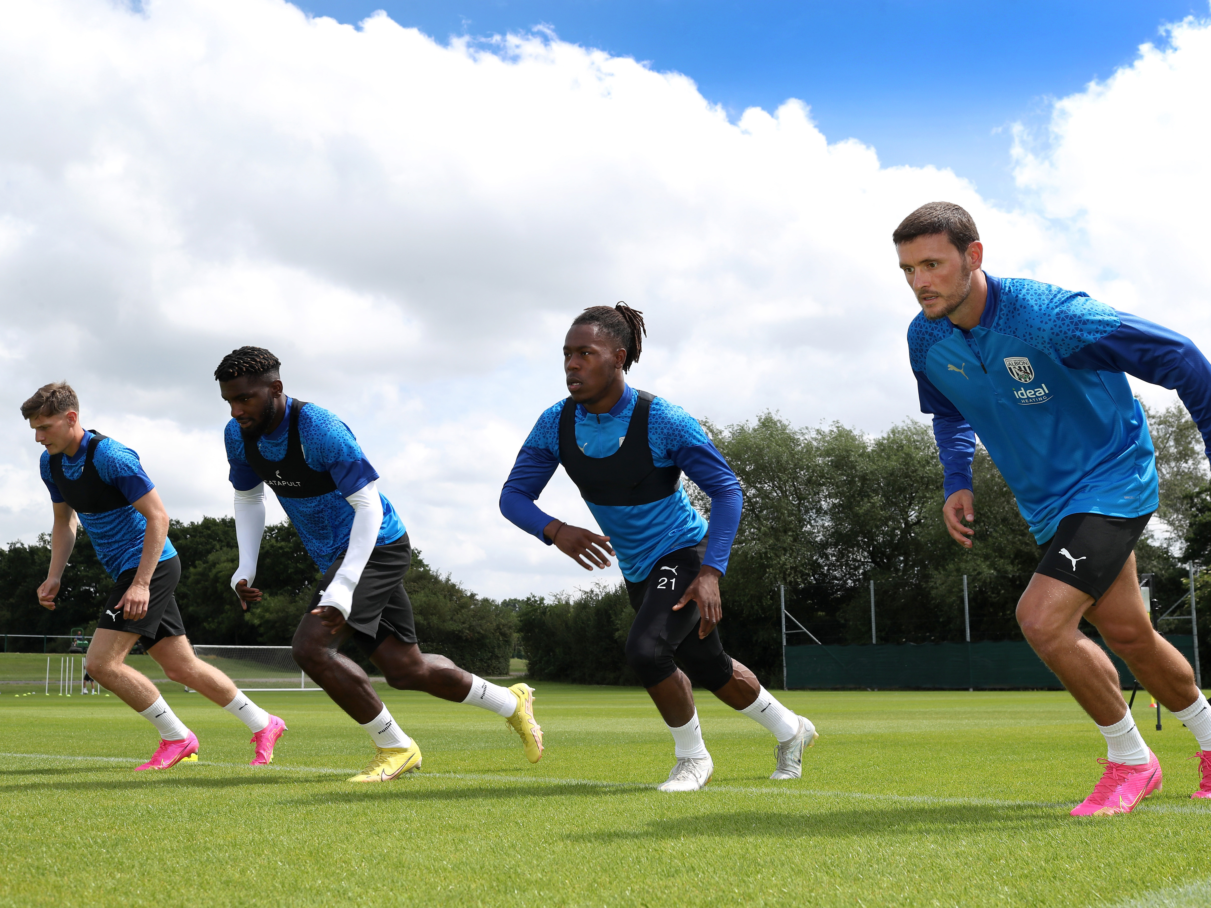 Four Albion players running forwards during a pre-season session