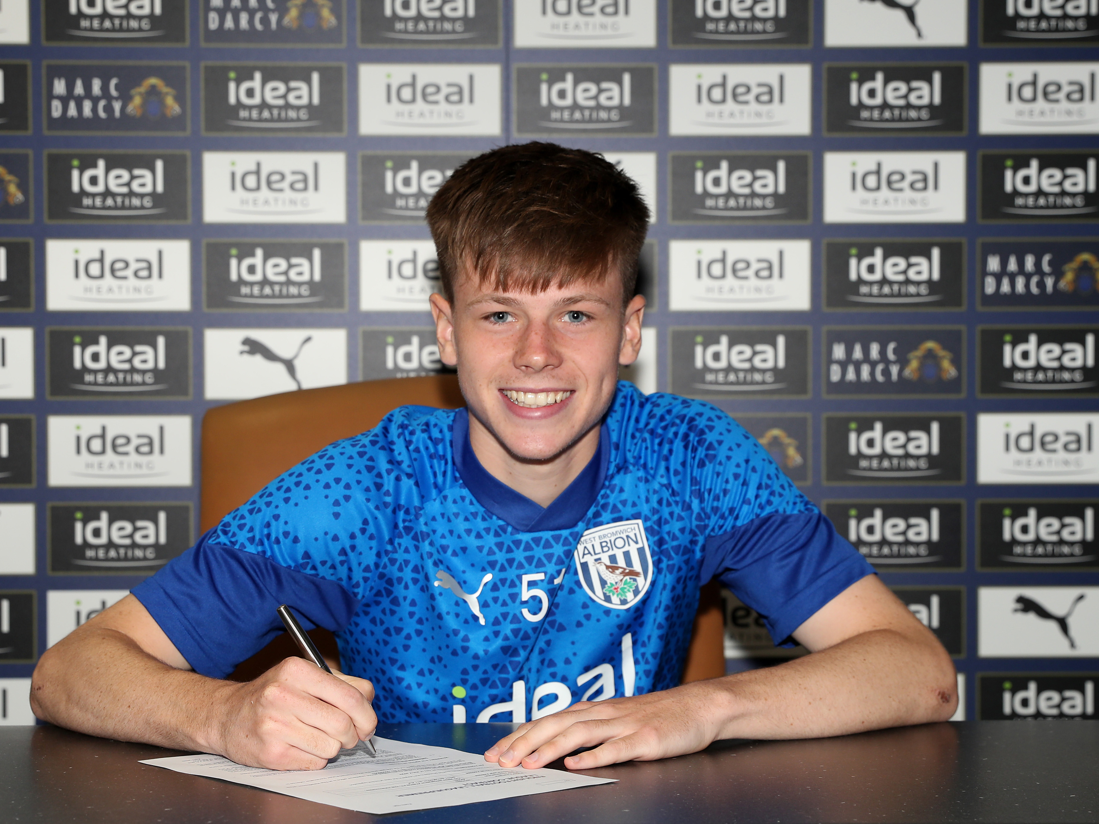 A photo of Fenton Heard signing his first professional contract