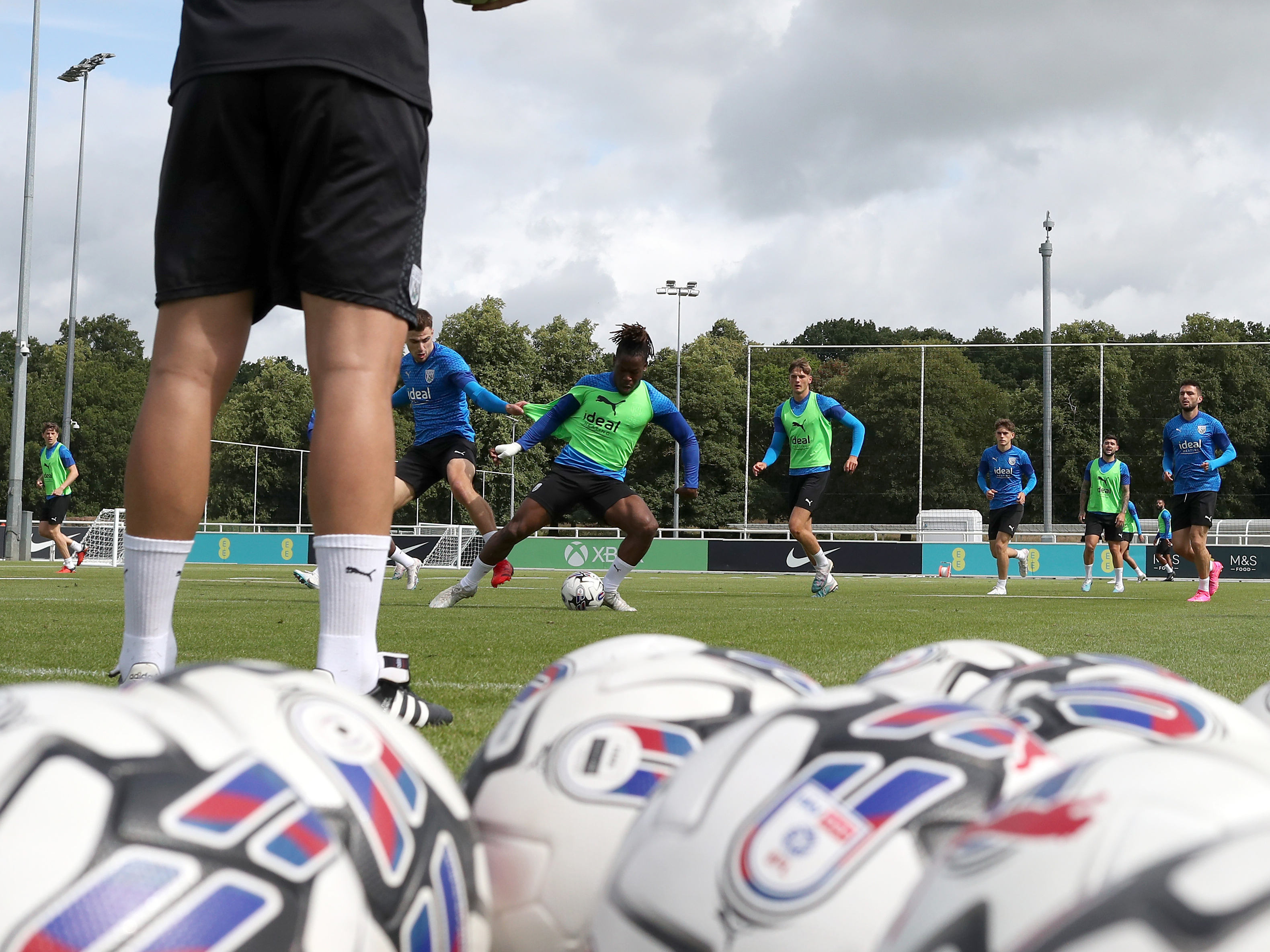 Albion players in training at St. George's Park with several footballs in shot