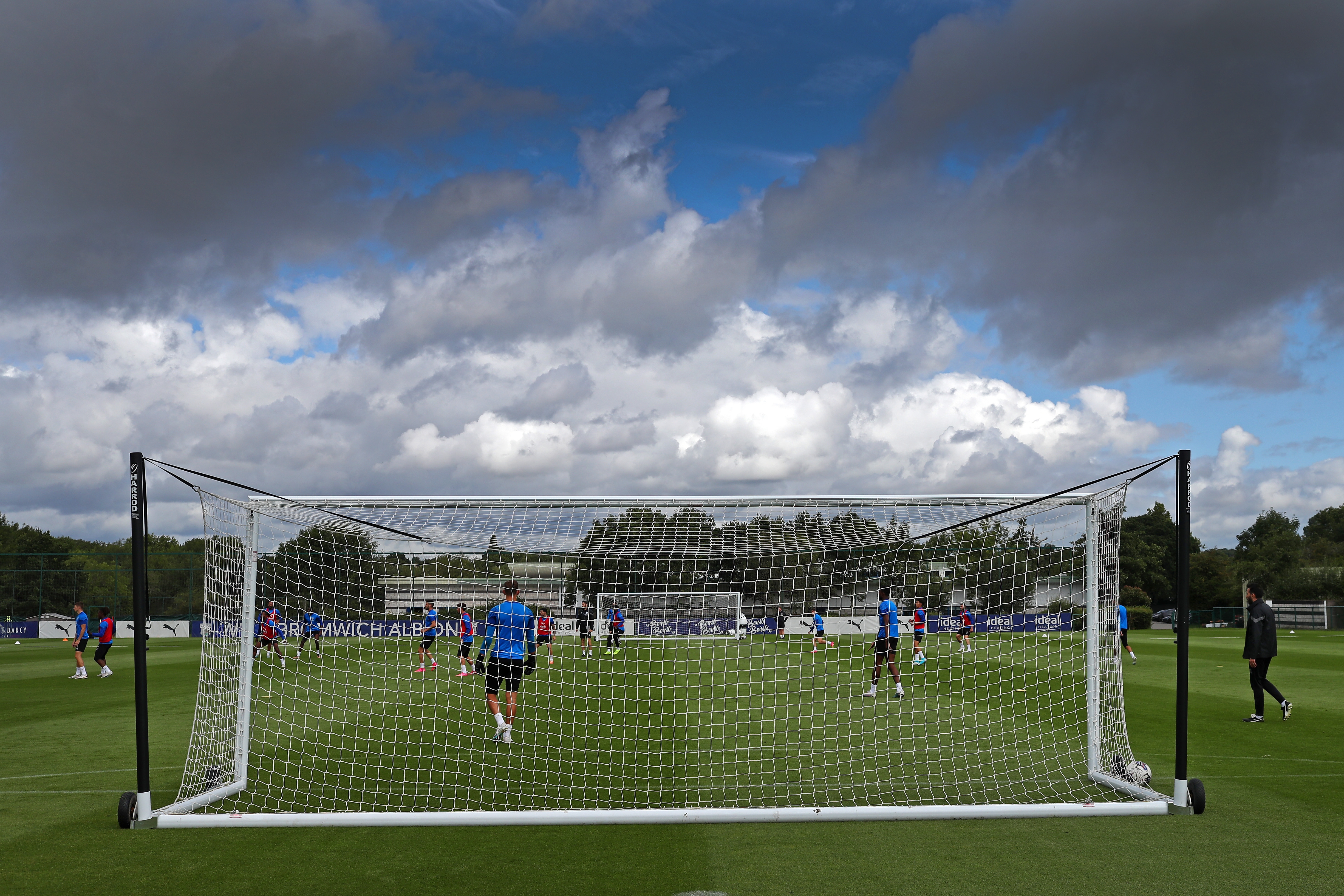 The training goal net with several Albion players behind it