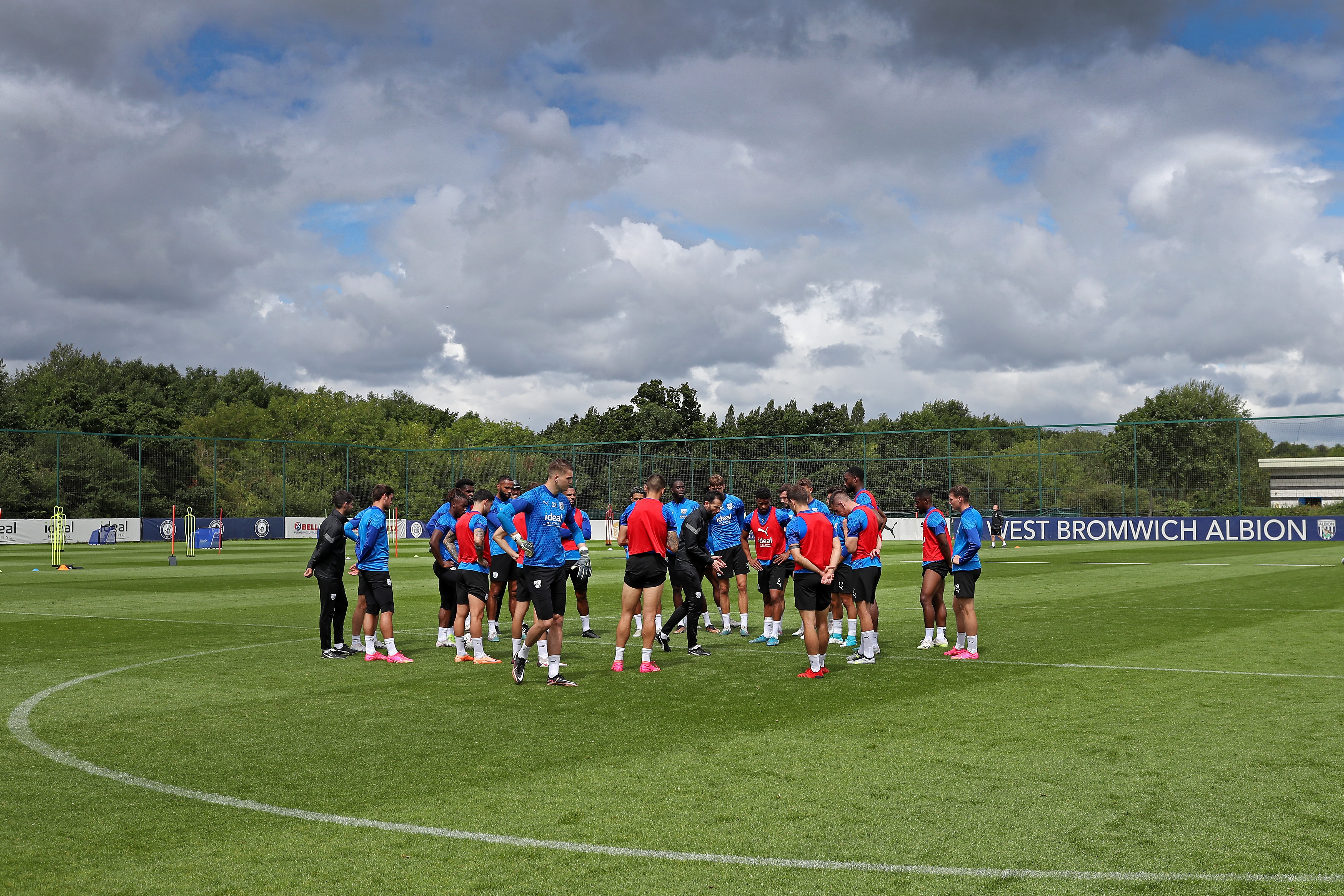 The players in a huddle on the training pitch