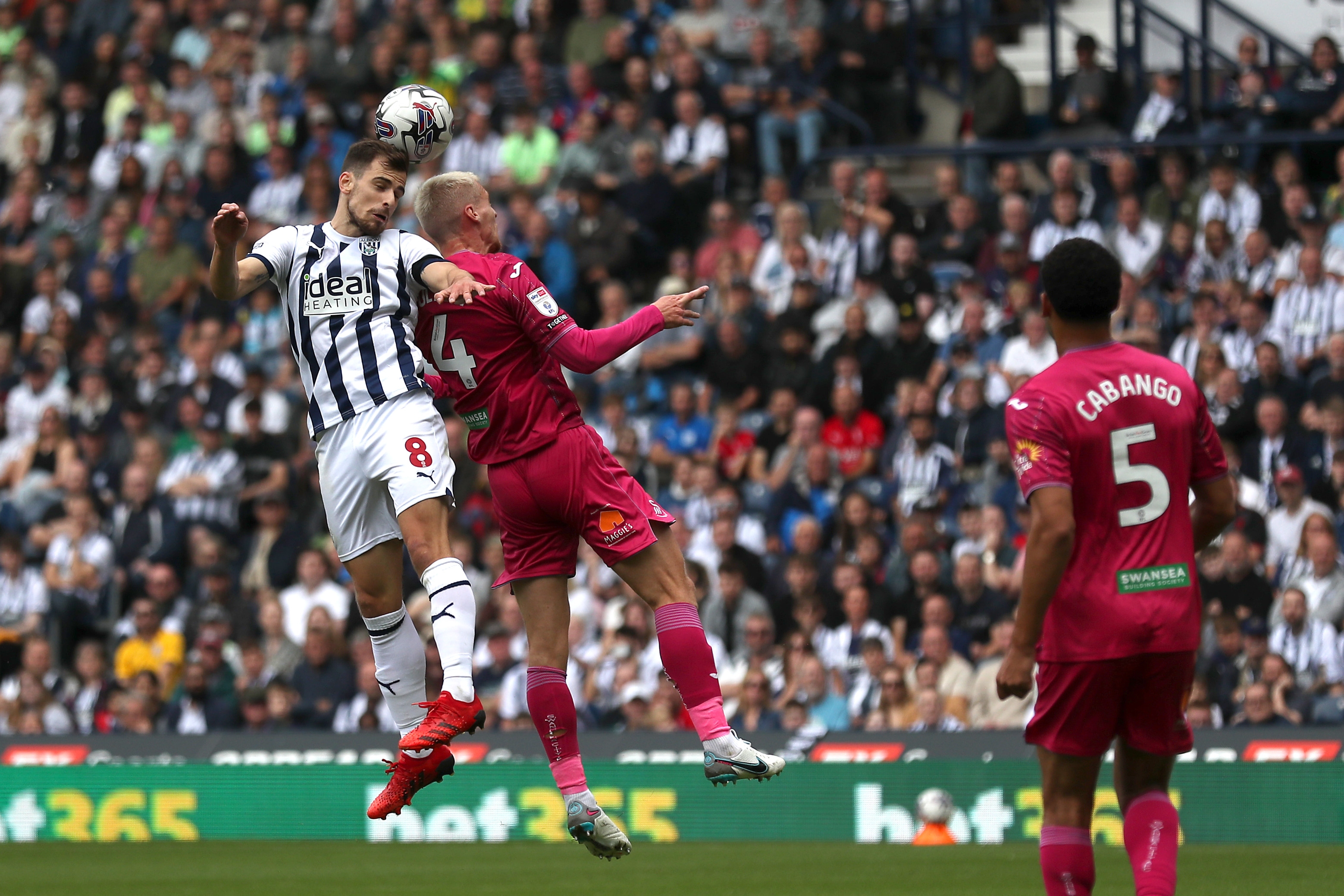 Jayson Molumby jumps for the ball against Swansea 