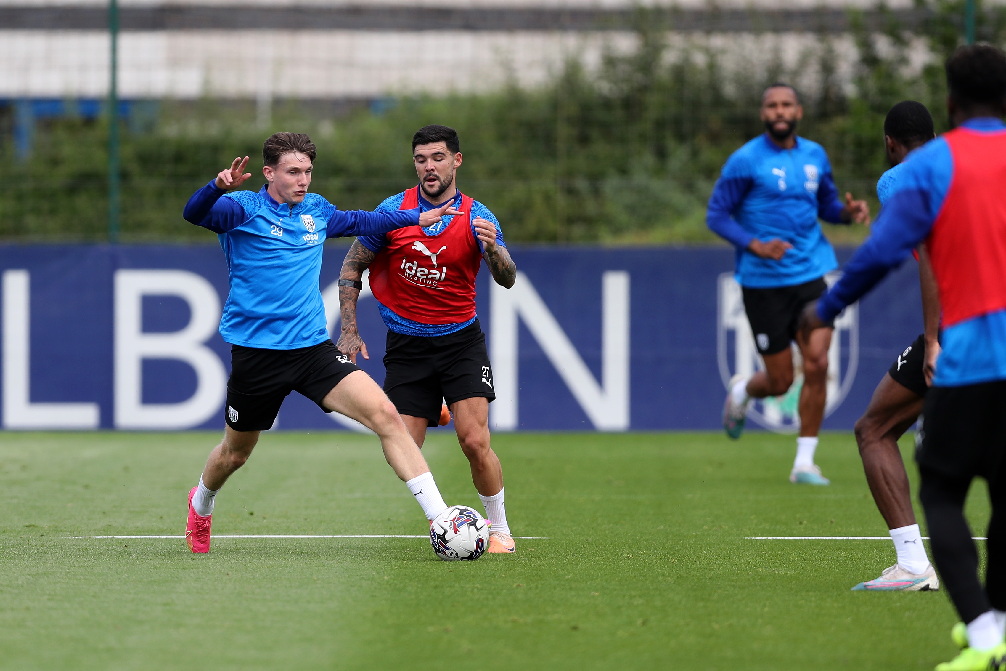 Taylor Gardner-Hickman and Alex Mowatt battle for the ball in training 
