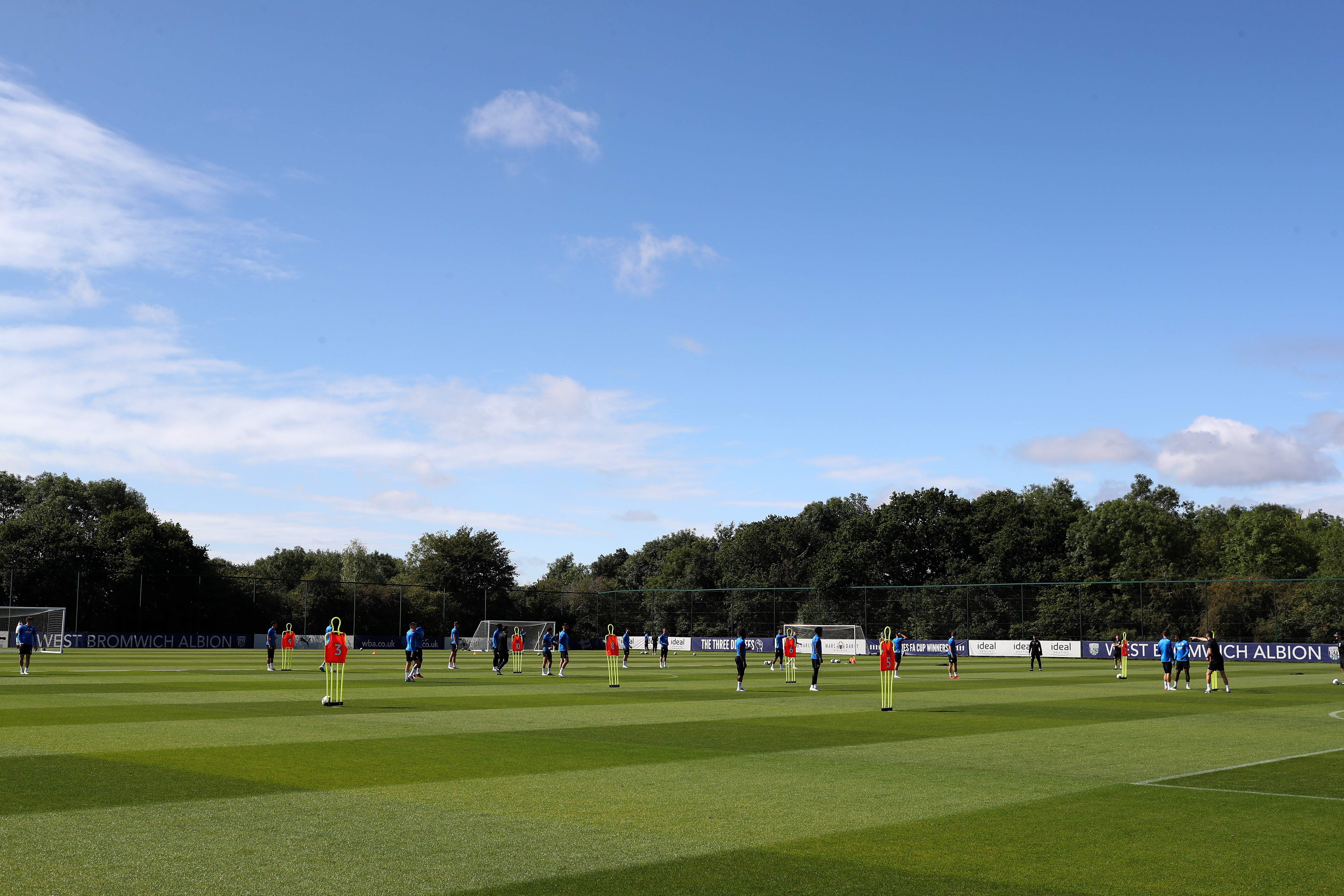 A wide view of the training pitch with the players training on it