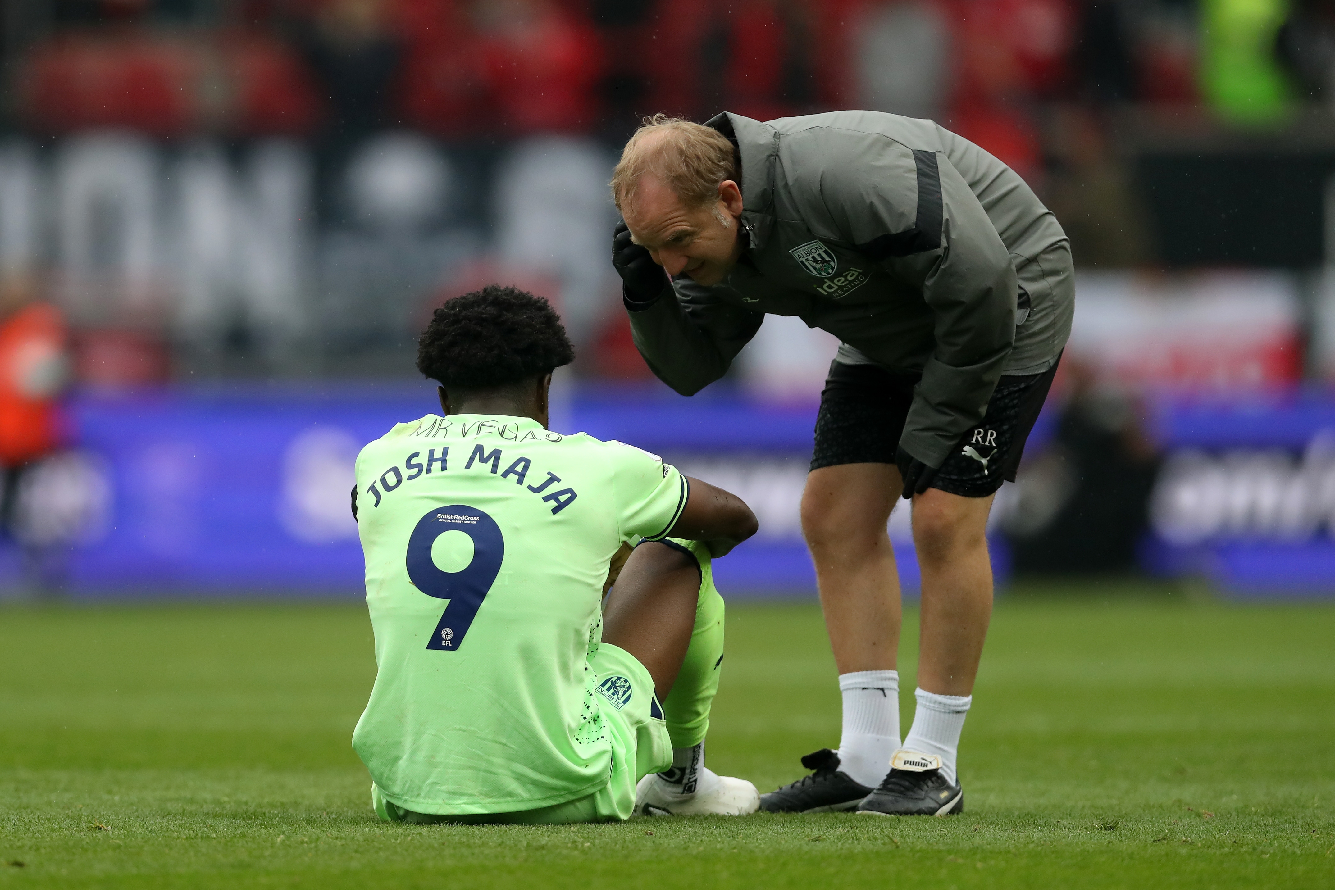 Josh Maja is seen to by physio Richie Rawlins after picking up an injury at Bristol City