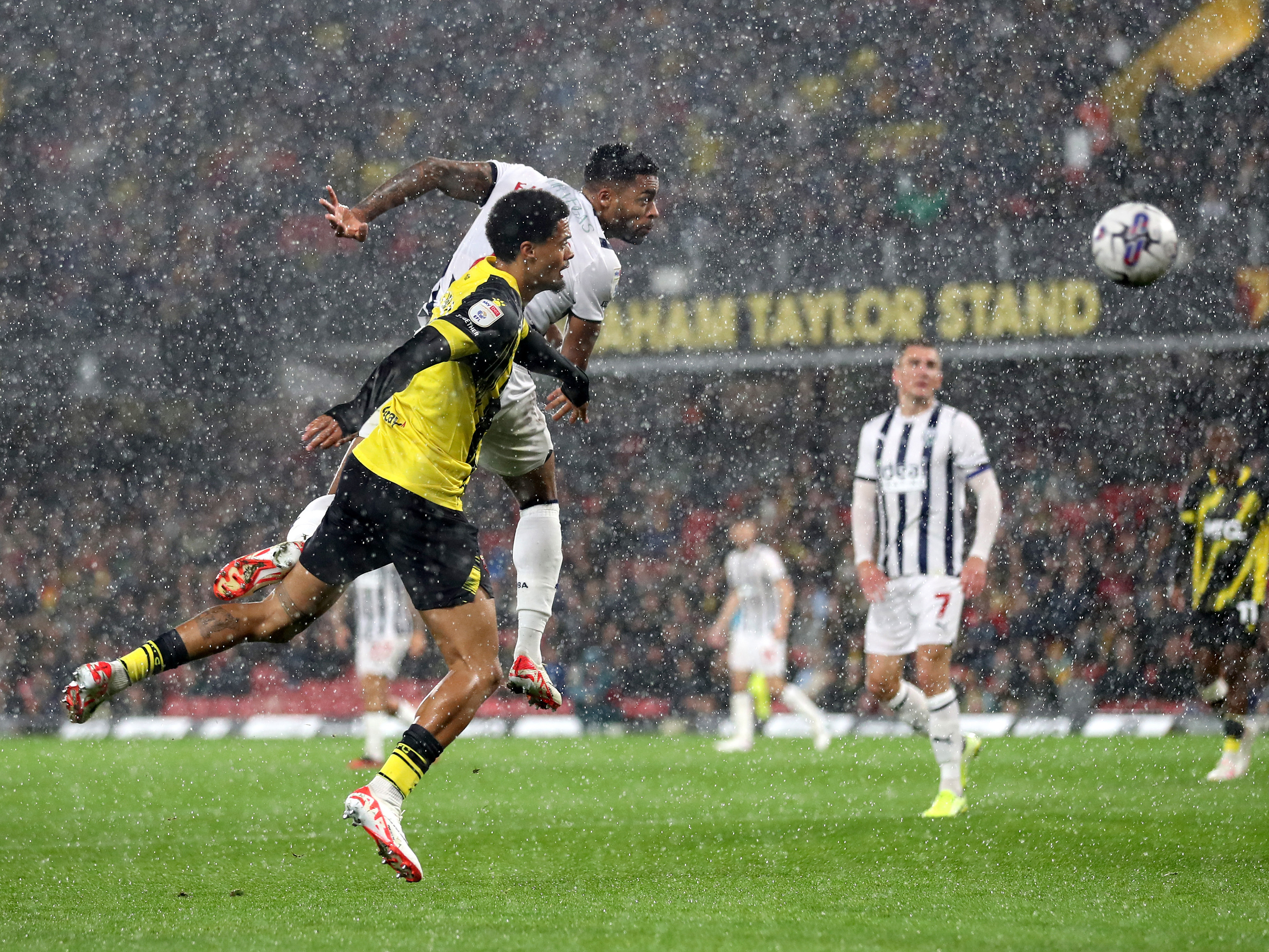 A photo of Darnell Furlong heading the ball v Watford in the rain at Vicarage Road.