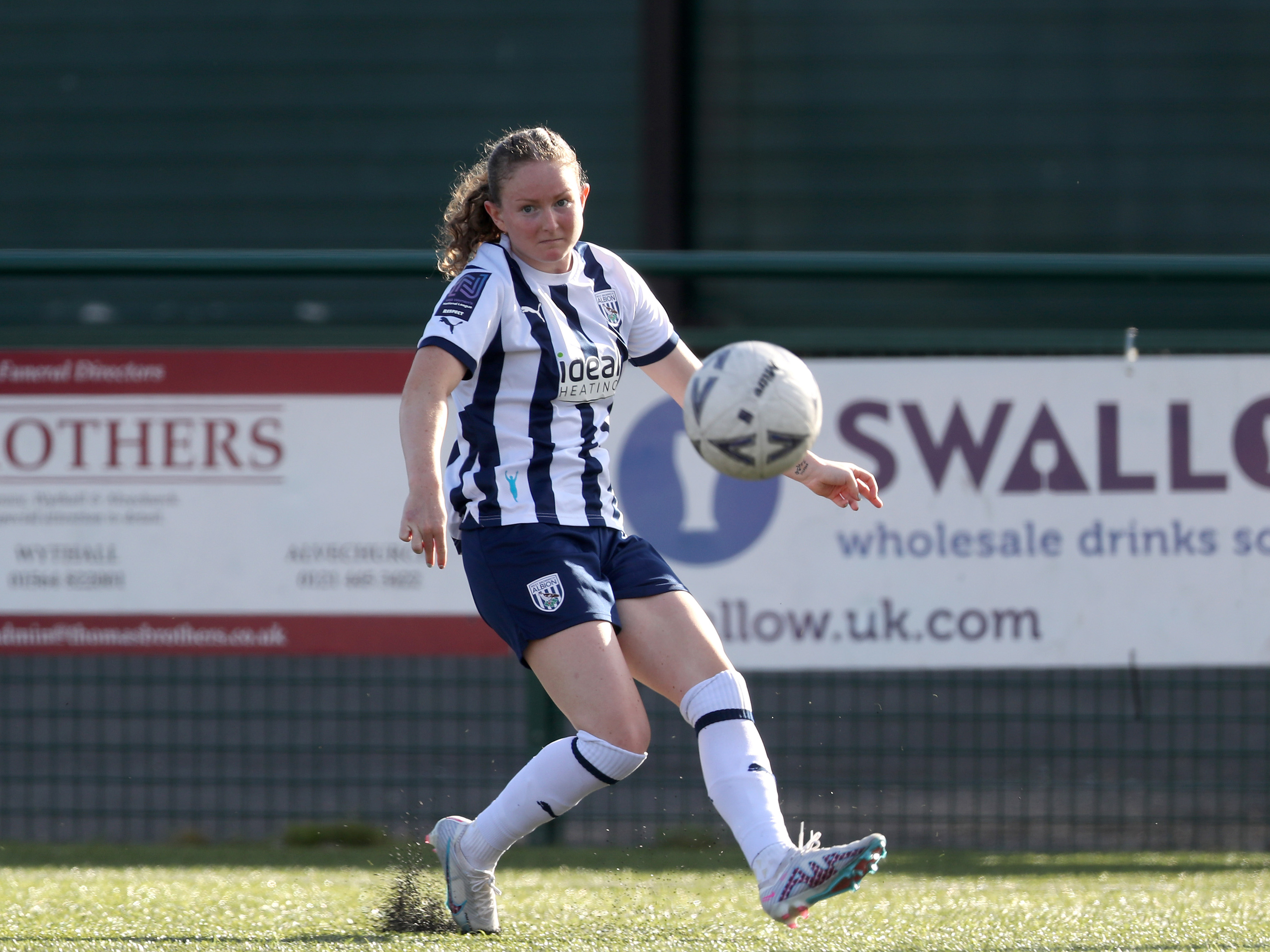 A photo of Albion Women's player Olivia Rabjohn on the ball at Redditch United's ground