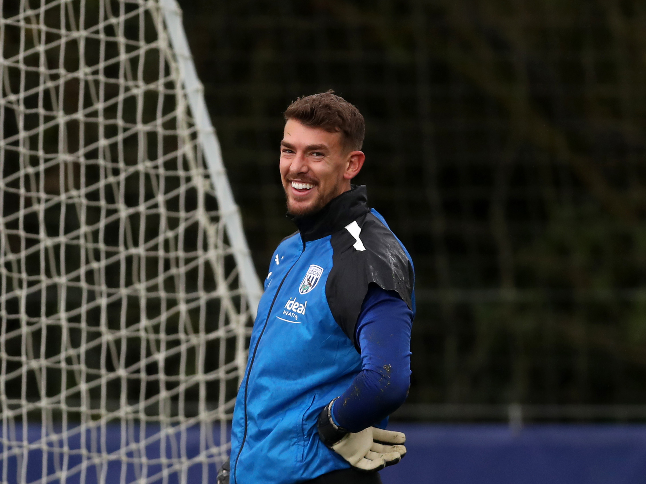 Alex Palmer smiling at the camera in training 
