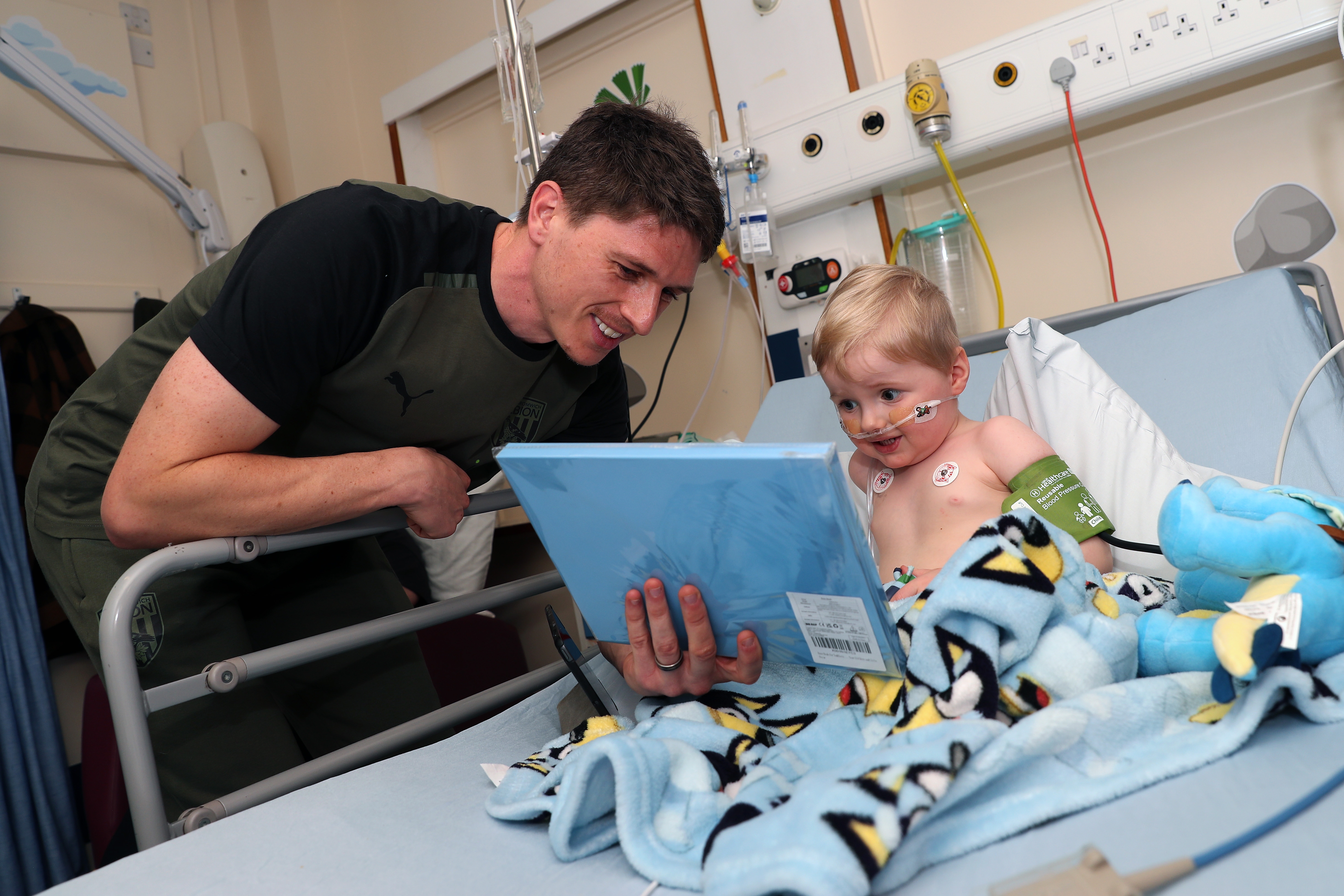 Adam Reach meets a young patient at Sandwell General Hospital
