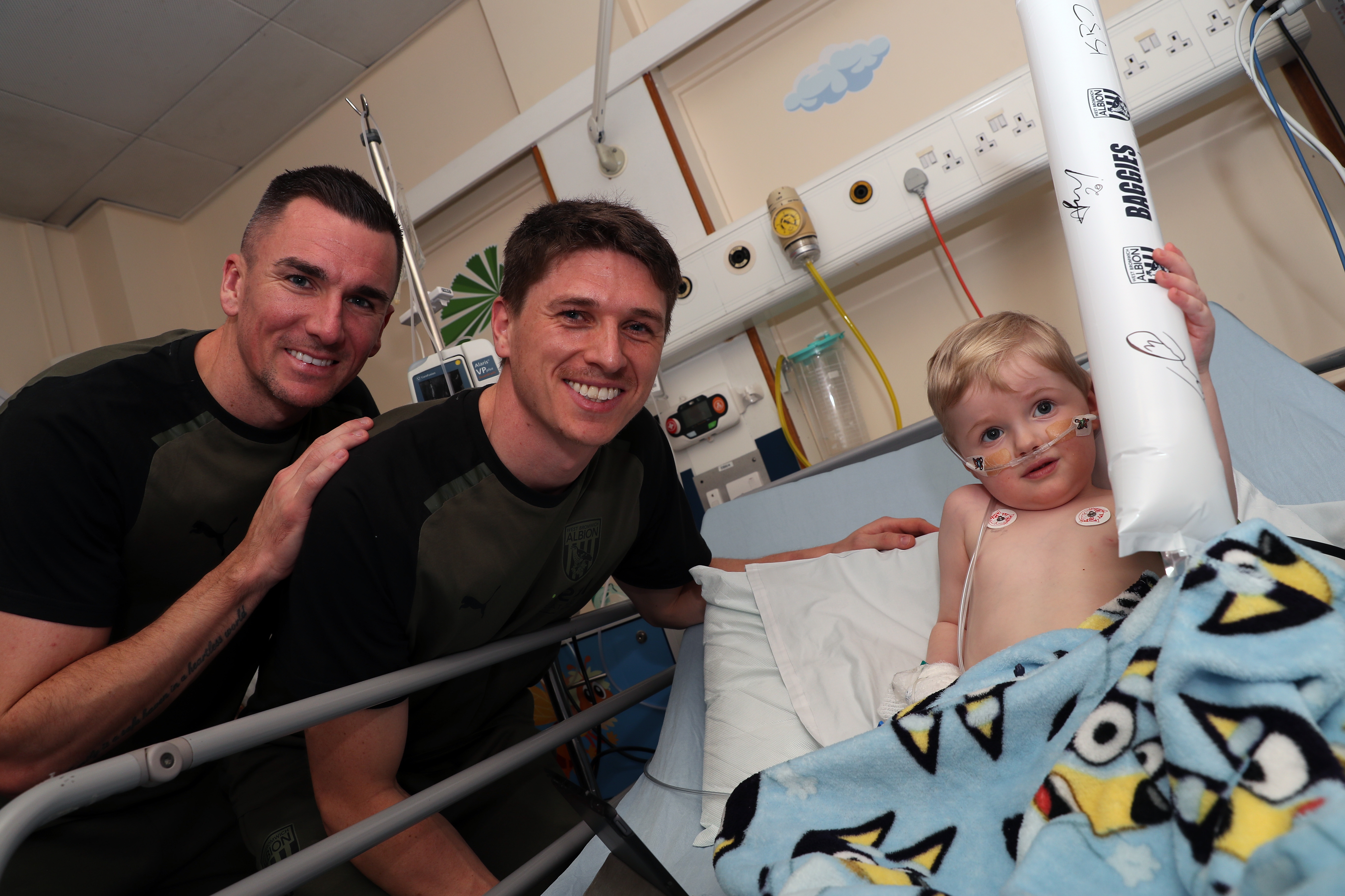 Jed Wallace and Adam Reach meet a young patient at Sandwell General Hospital