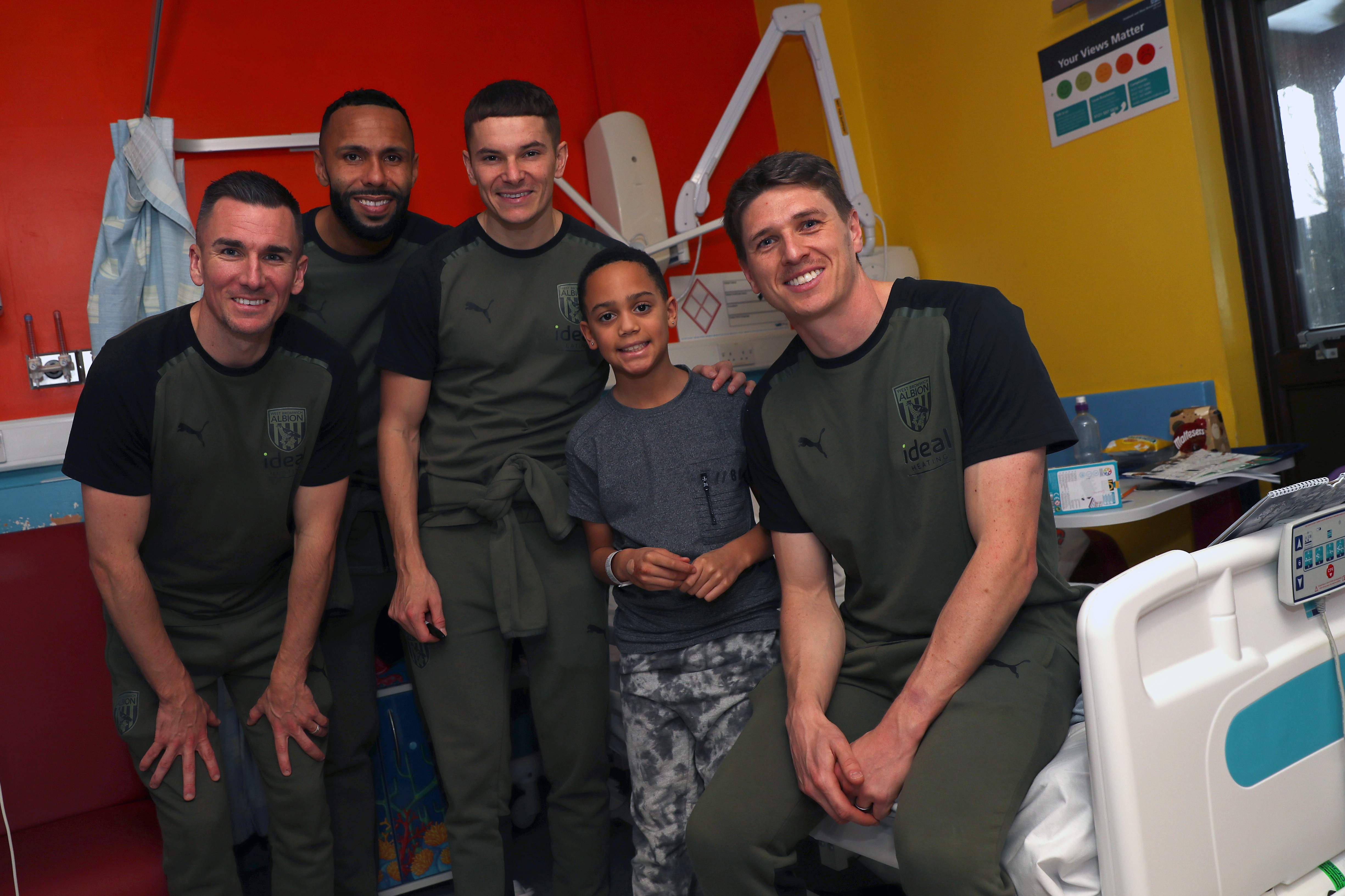 Jed Wallace, Adam Reach, Kyle Bartley and Conor Townsend pose for a photo with patients at Sandwell General Hospital