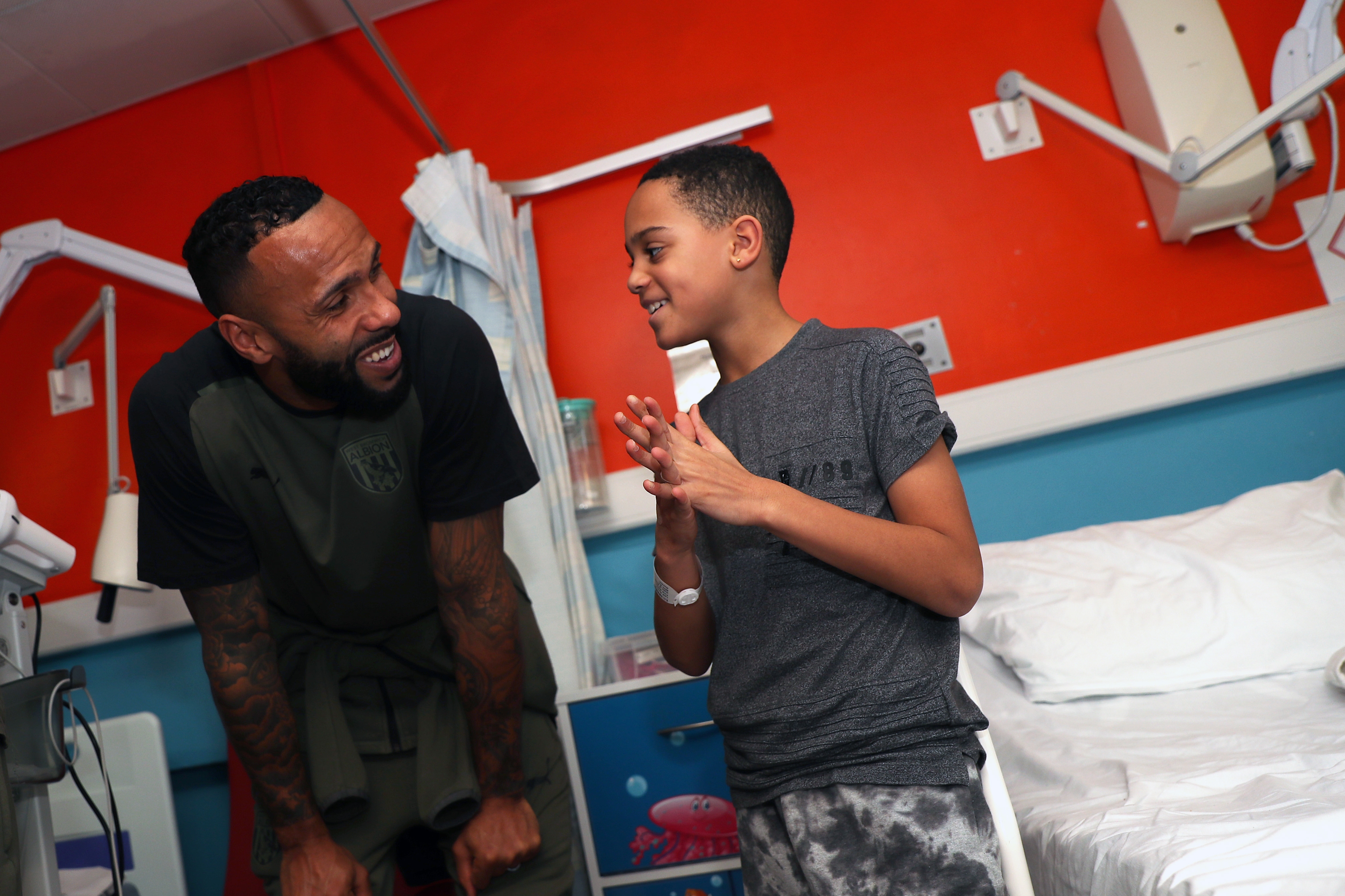 Kyle Bartley meets a young patient at Sandwell General Hospital