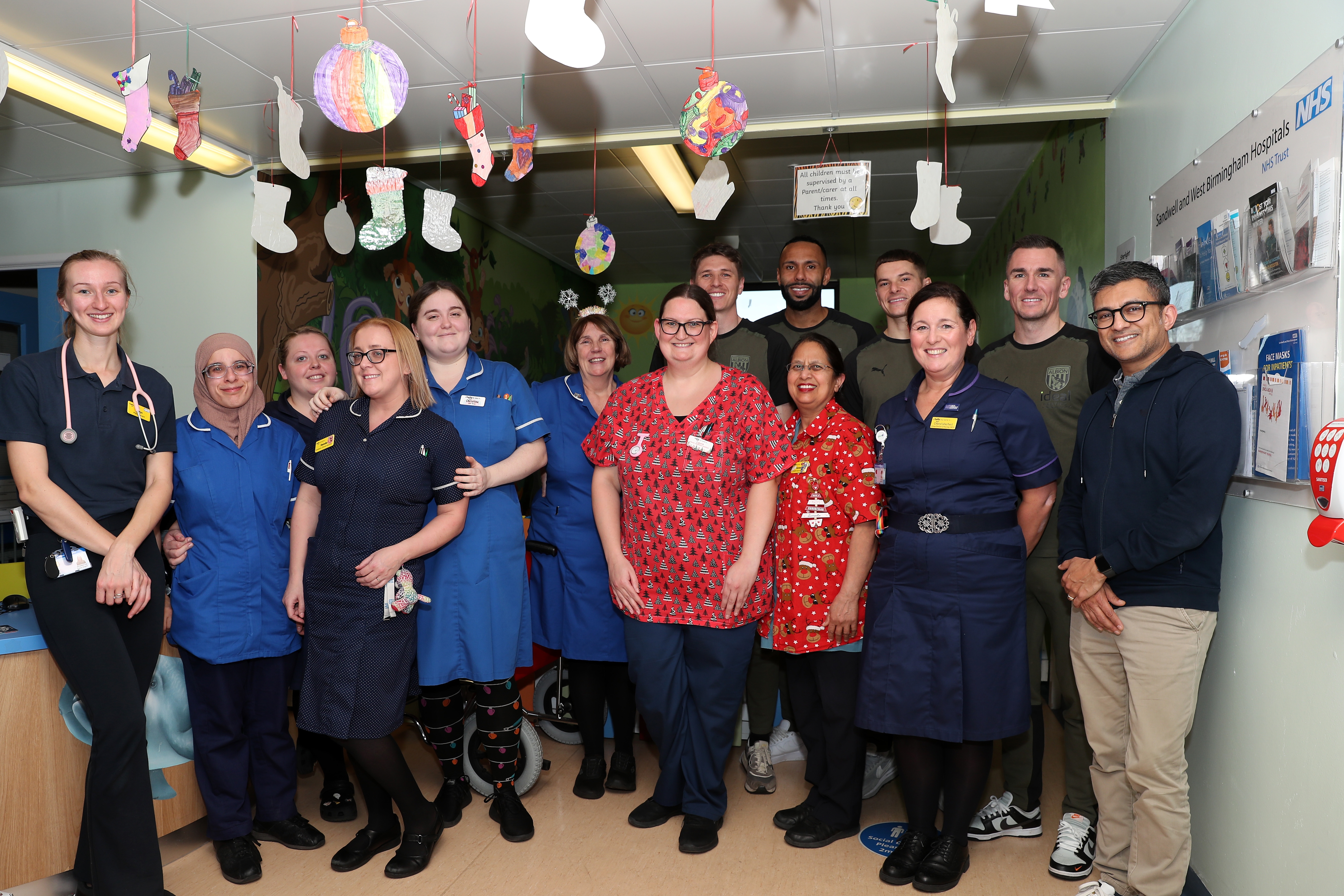 Kyle Bartley, Conor Townsend, Adam Reach and Jed Wallace pose for a photo with NHS workers at Sandwell General Hospital