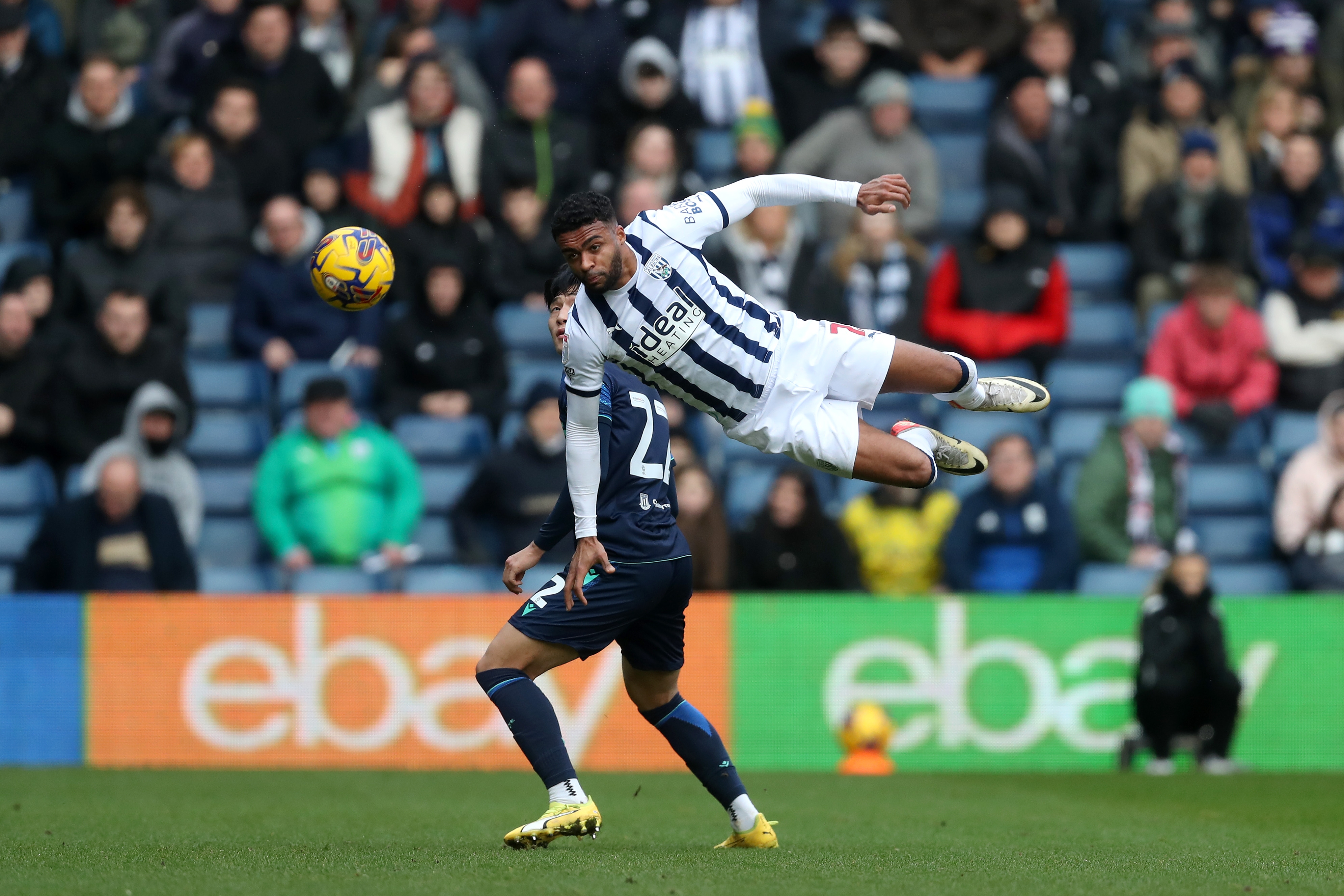 Darnell Furlong flying through the air to head the ball against Stoke
