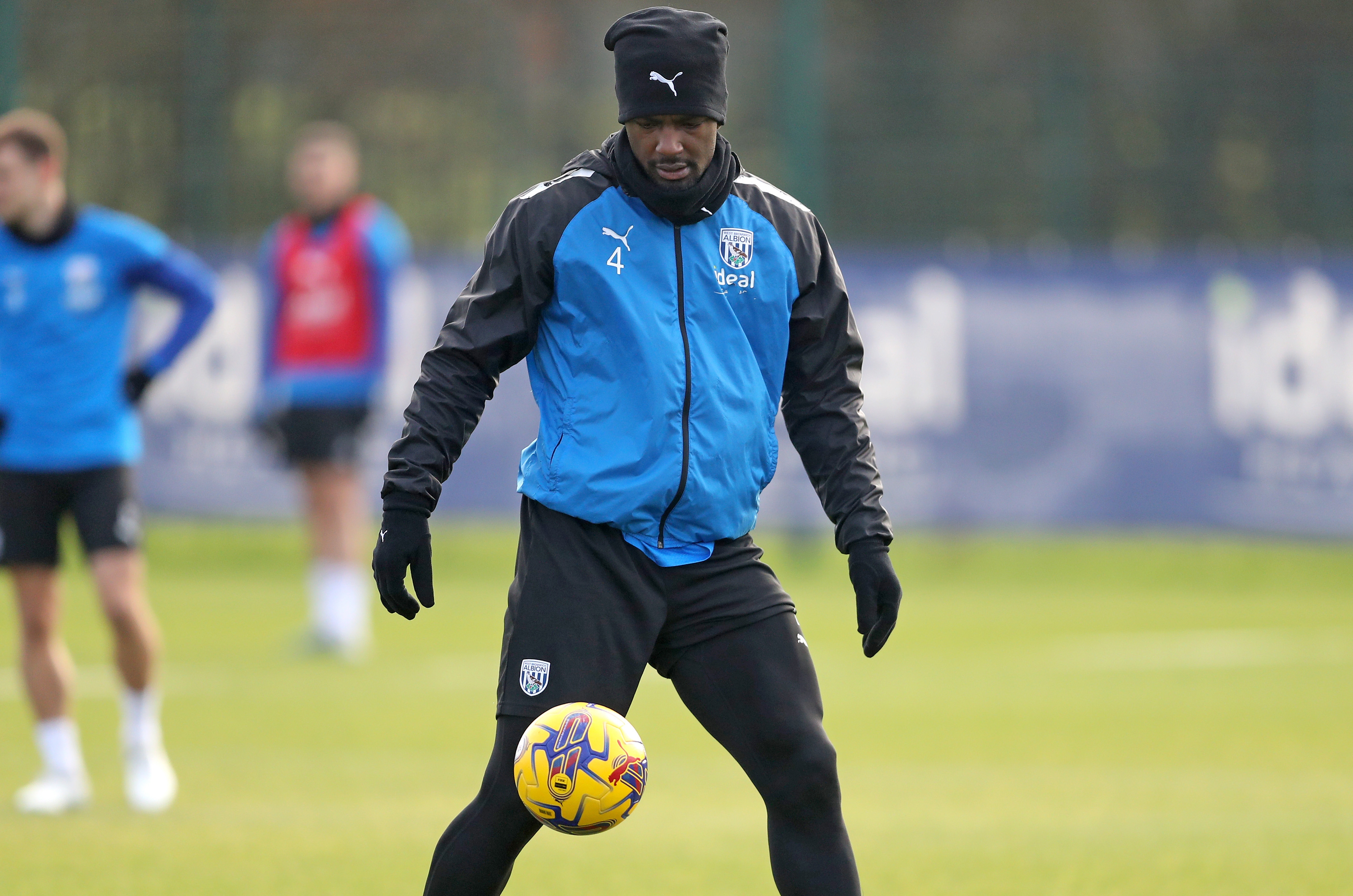 Cedric Kipre on the ball in training while wearing a hat