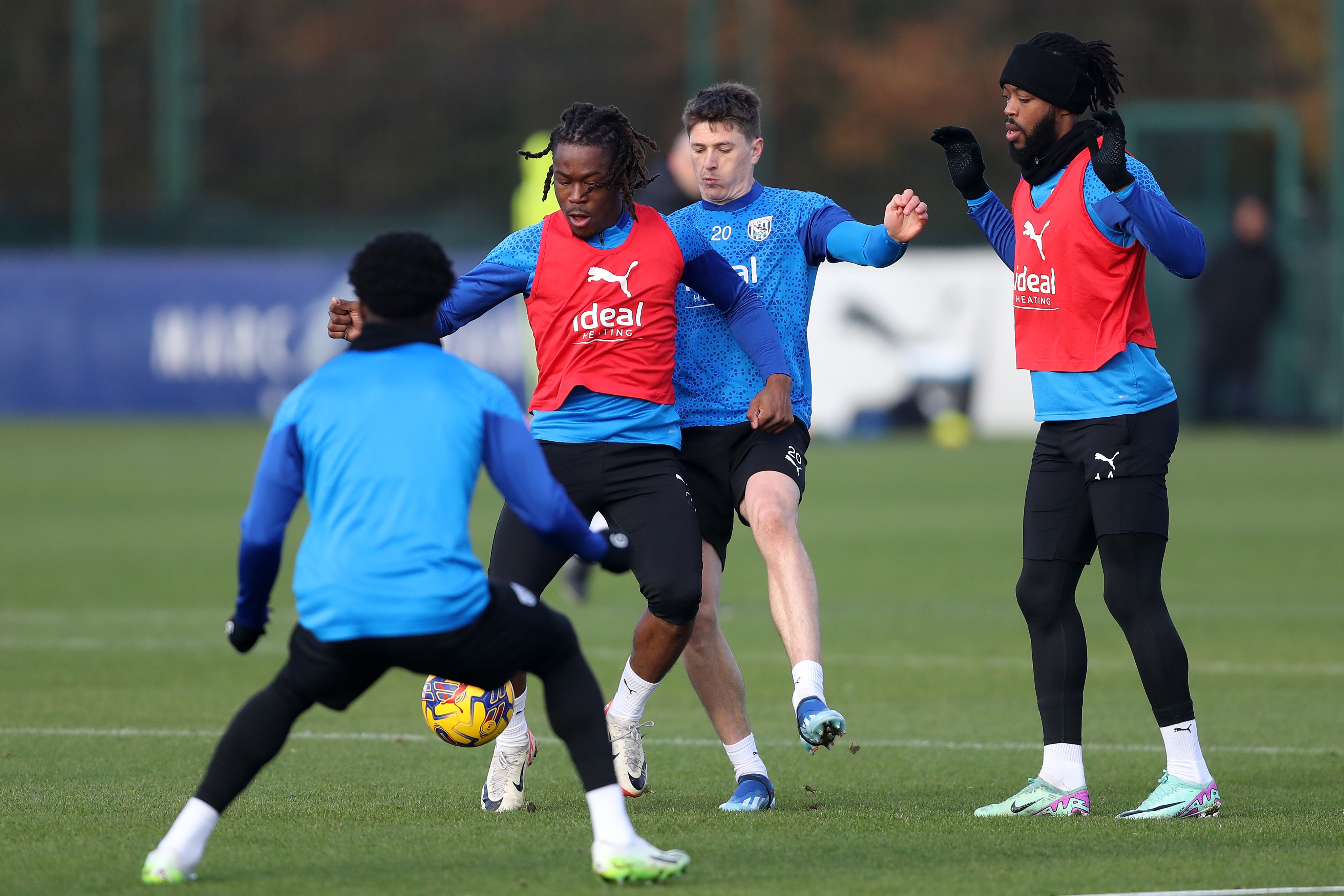 Brandon Thomas-Asante under pressure from other players in training 