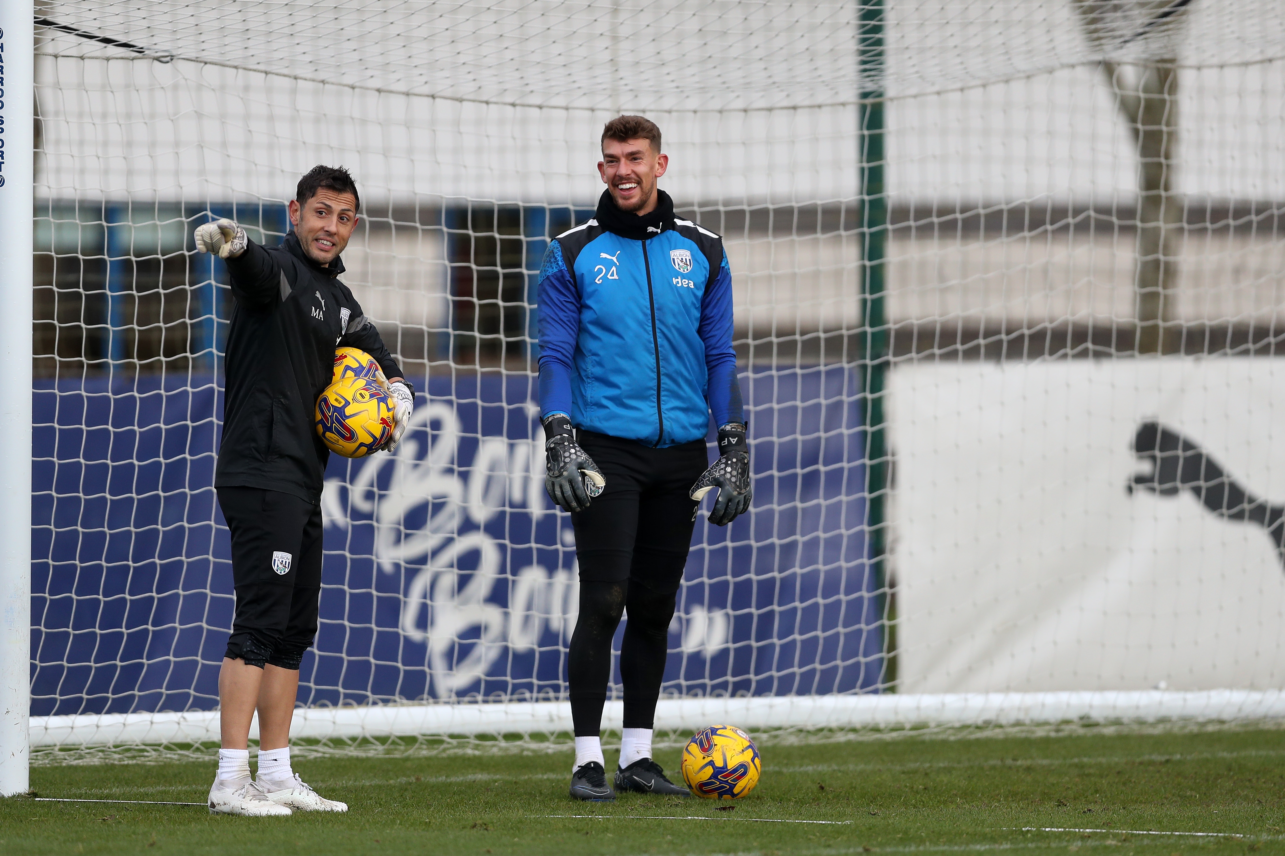 Alex Palmer laughing in training with goalkeeping coach Marcos Abad