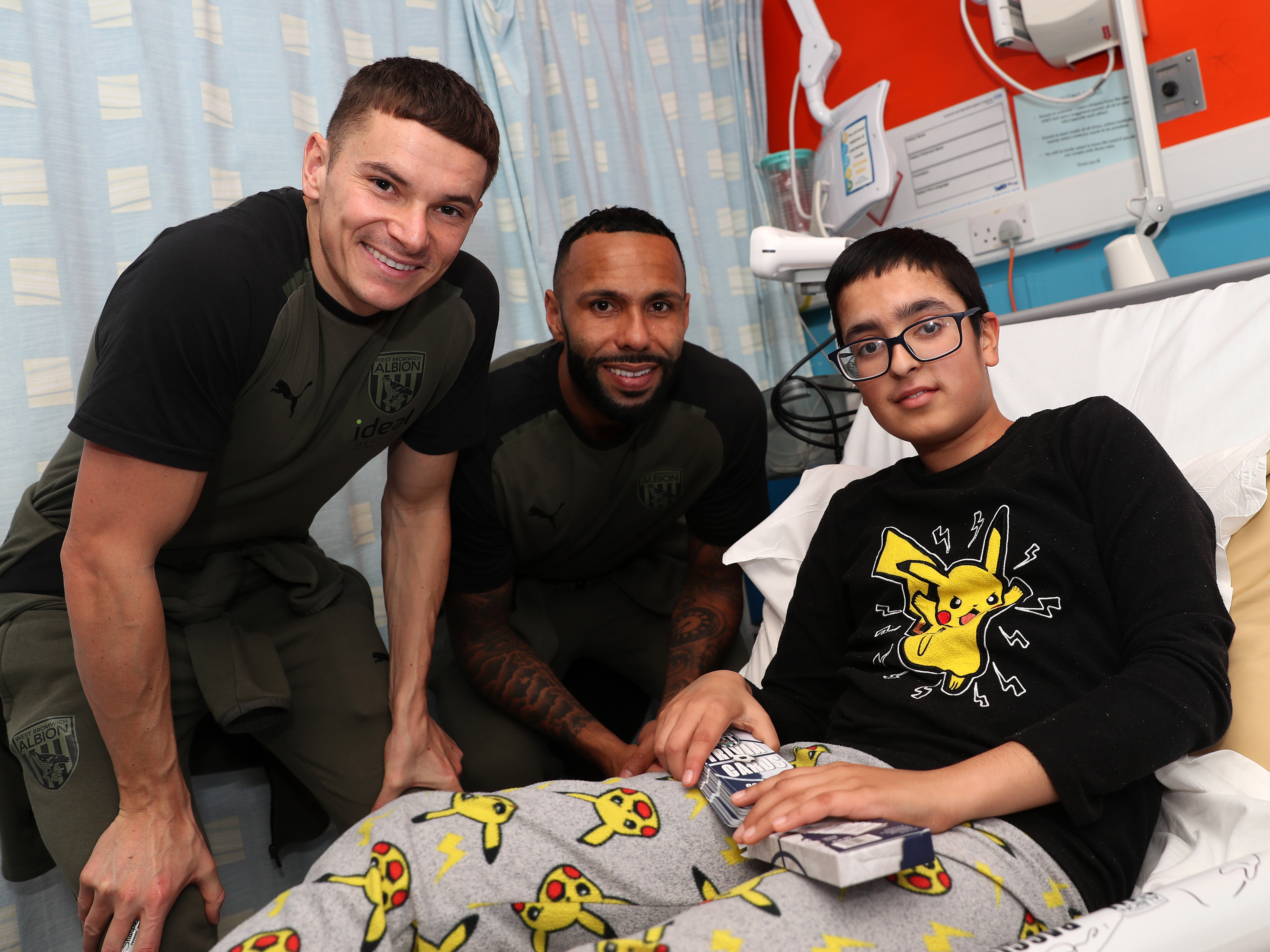 Conor Townsend and Kyle Bartley pose for a photo with a young patient at Sandwell General Hospital