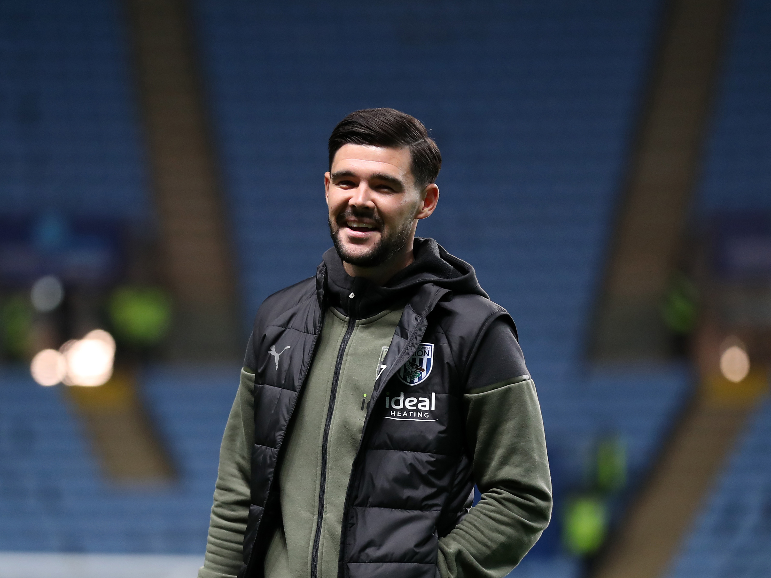 Alex Mowatt smiling in his tracksuit before a match