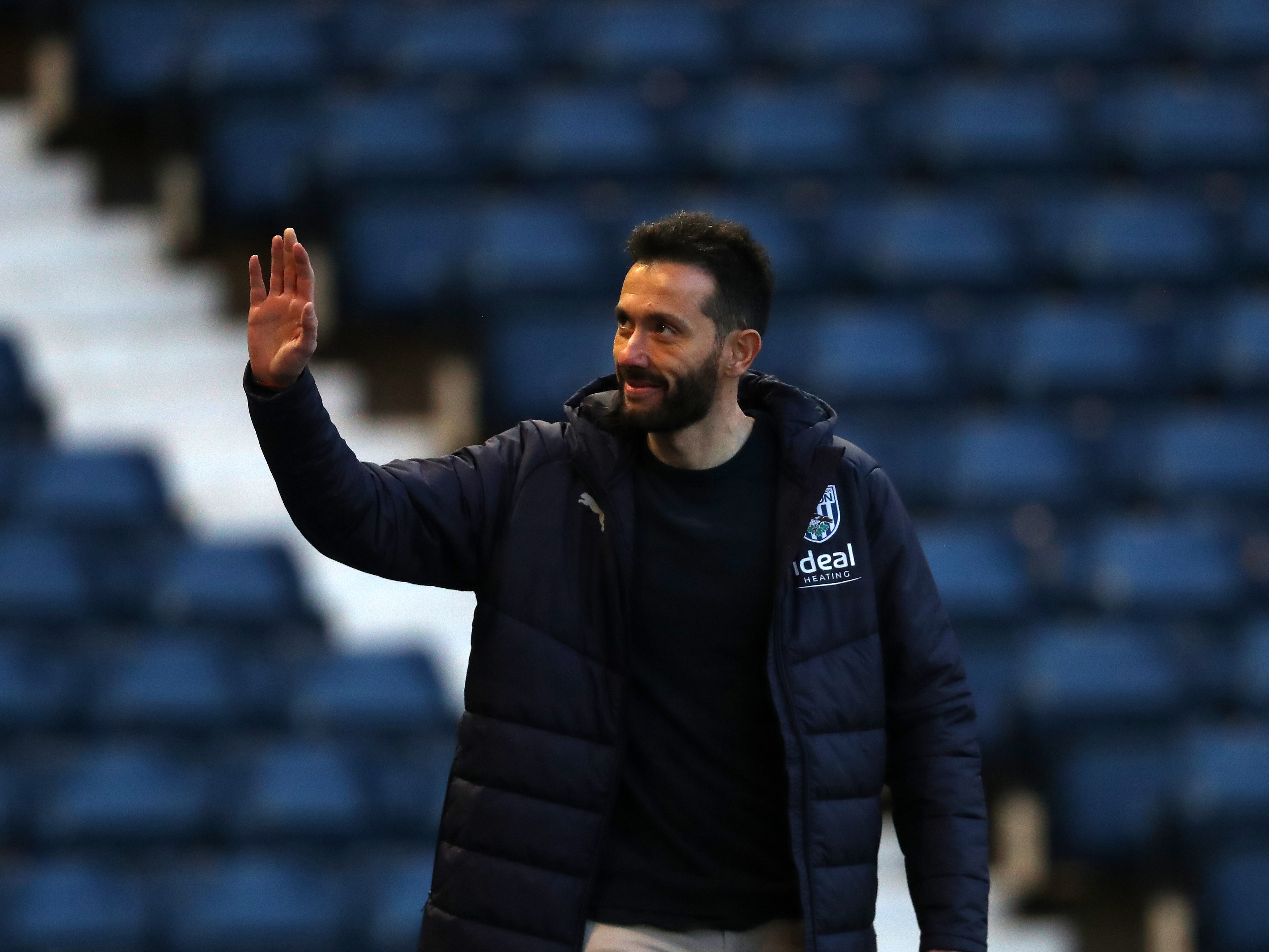 Carlos Corberán waving to supporters upon arrival at The Hawthorns