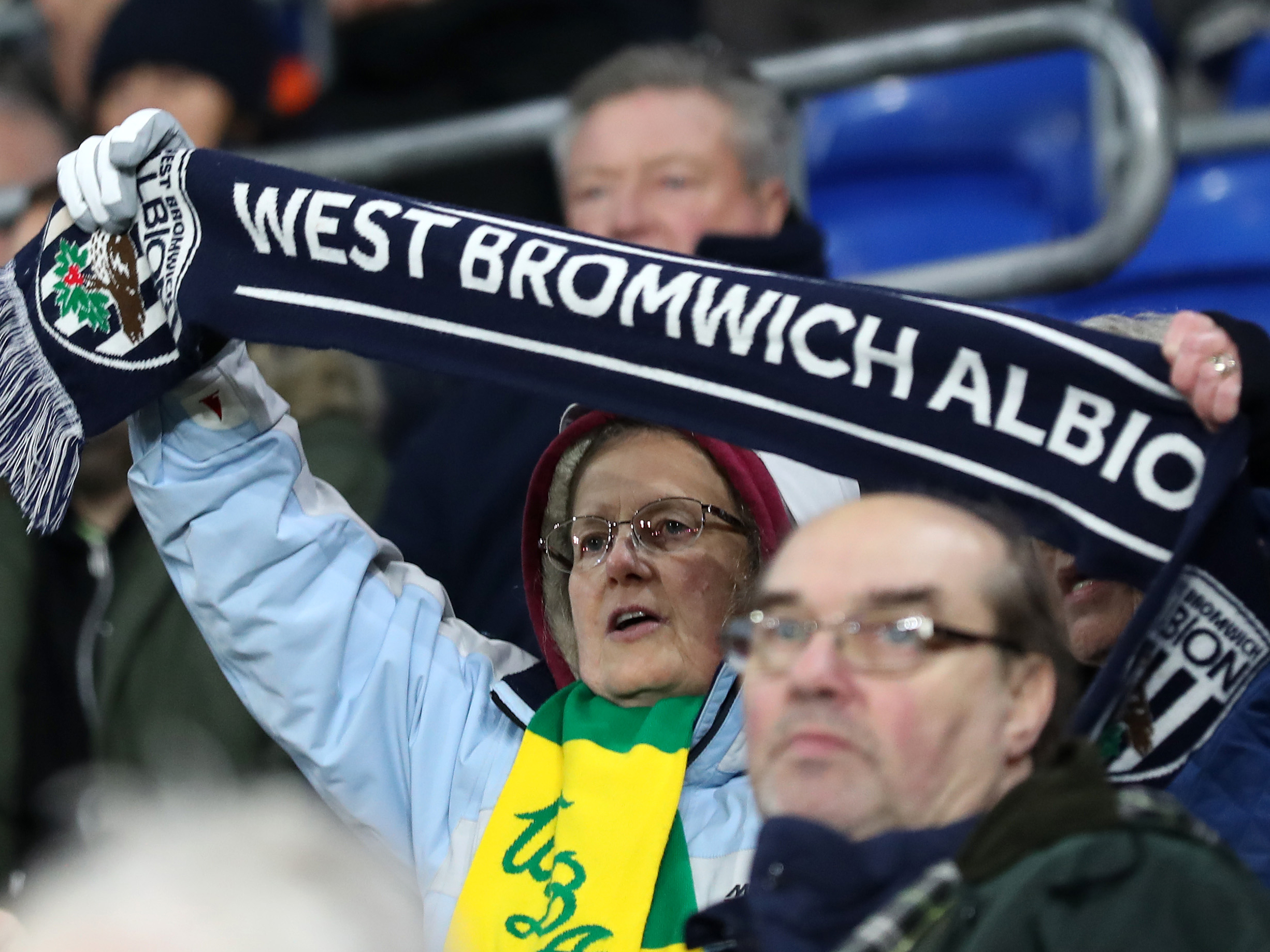 Albion fan holding a club scarf 