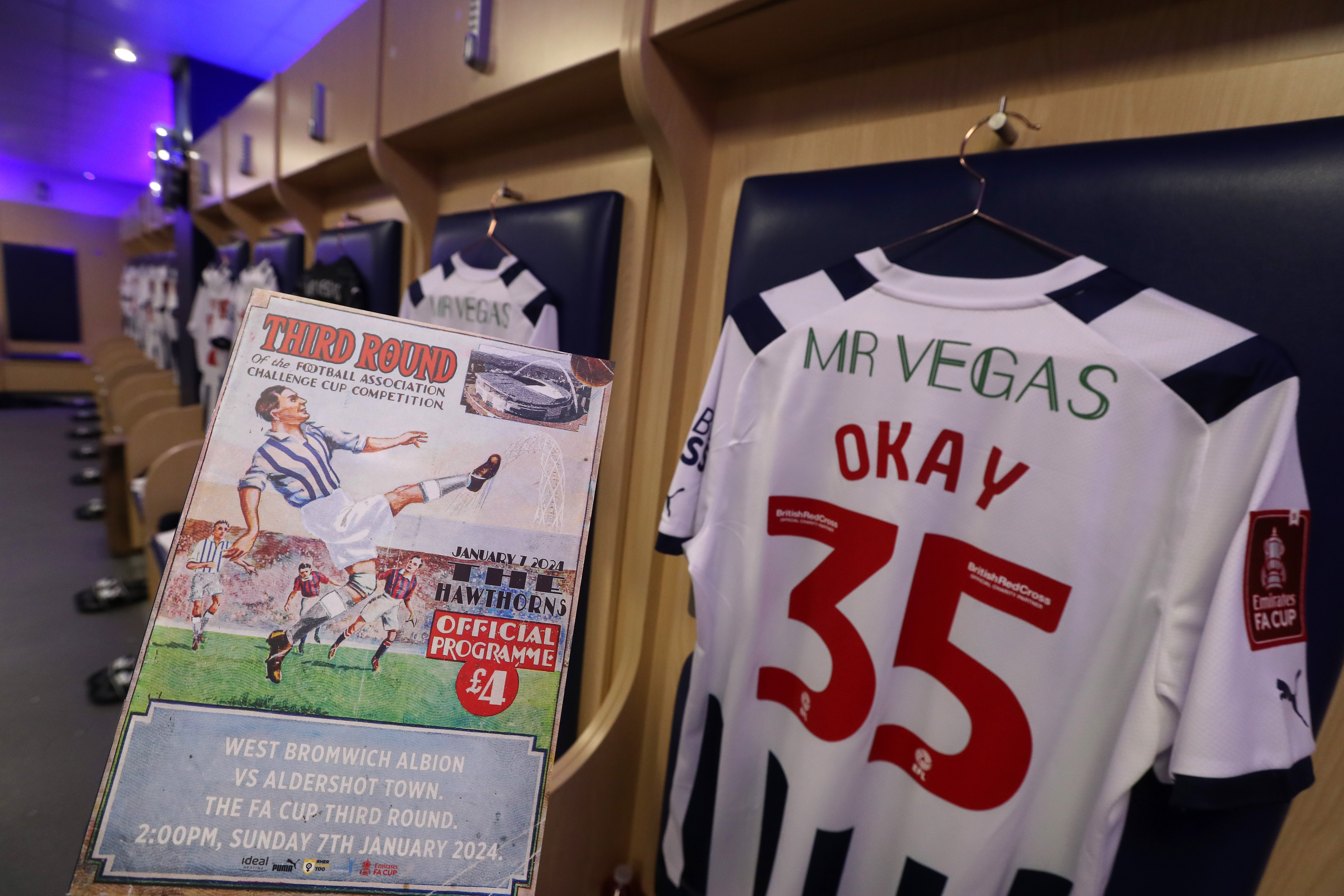The matchday programme and the back of Okay Yokuslu's shirt in the dressing room before the Aldershot game