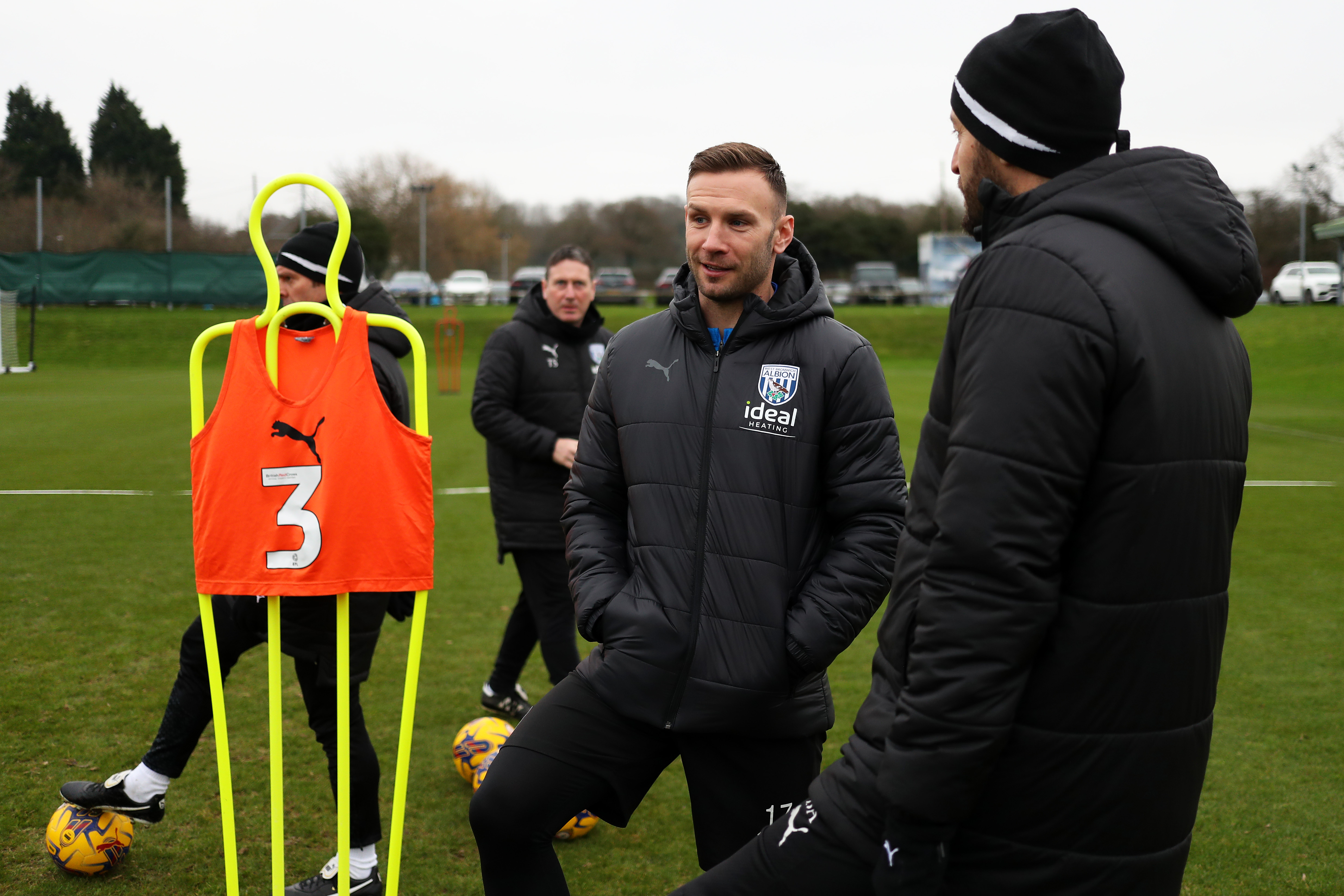 Andi Weimann smiling talking to Albion staff out on the training pitch