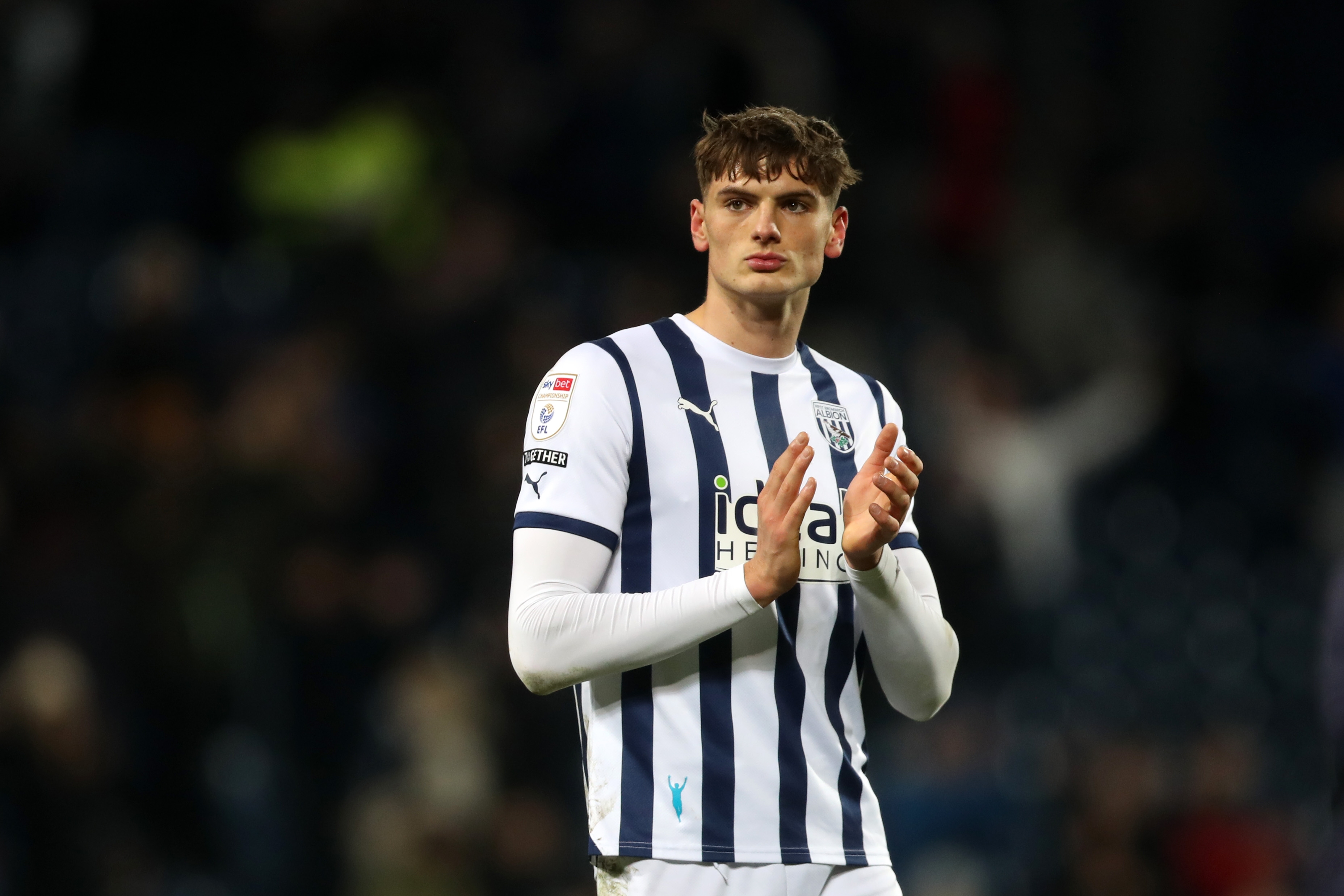 Caleb Taylor applauds supporters after full time against Blackburn